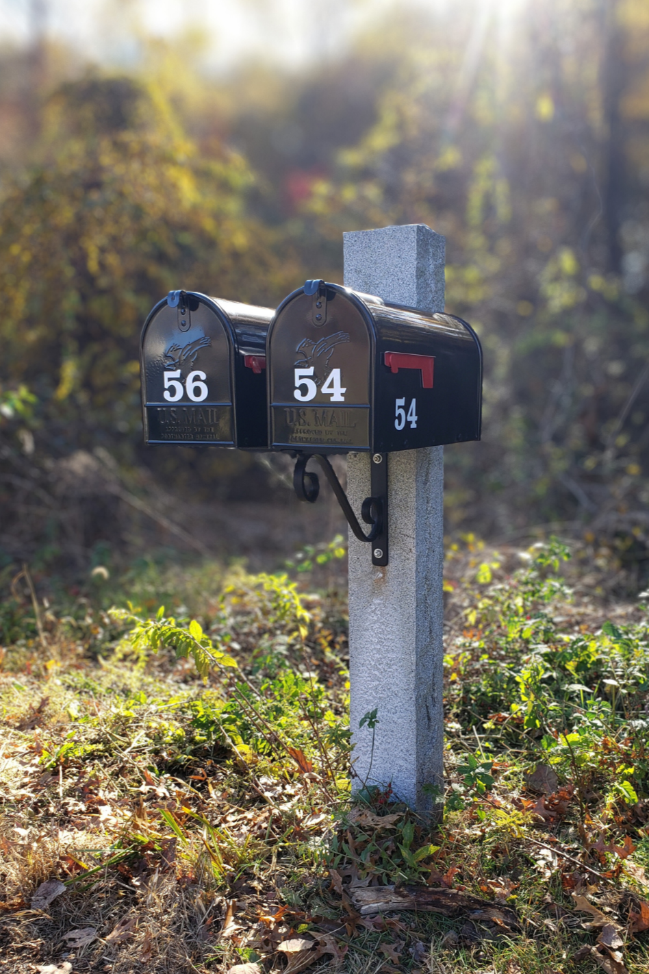 two gibraltar mailboxes mounted to the front of a granite mailbox post  fully installed in Groton Ma