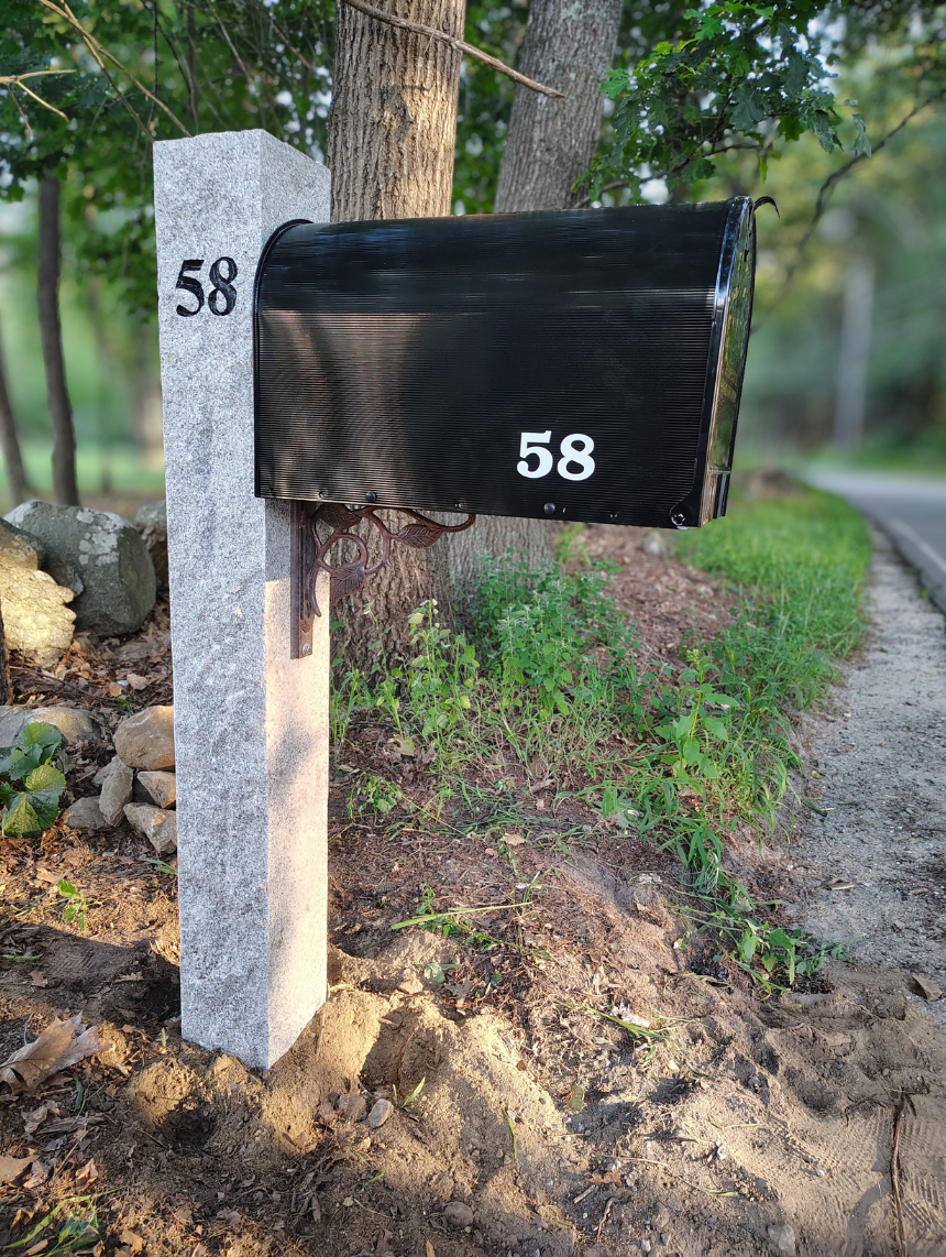 house number engraved into granite mailbox post