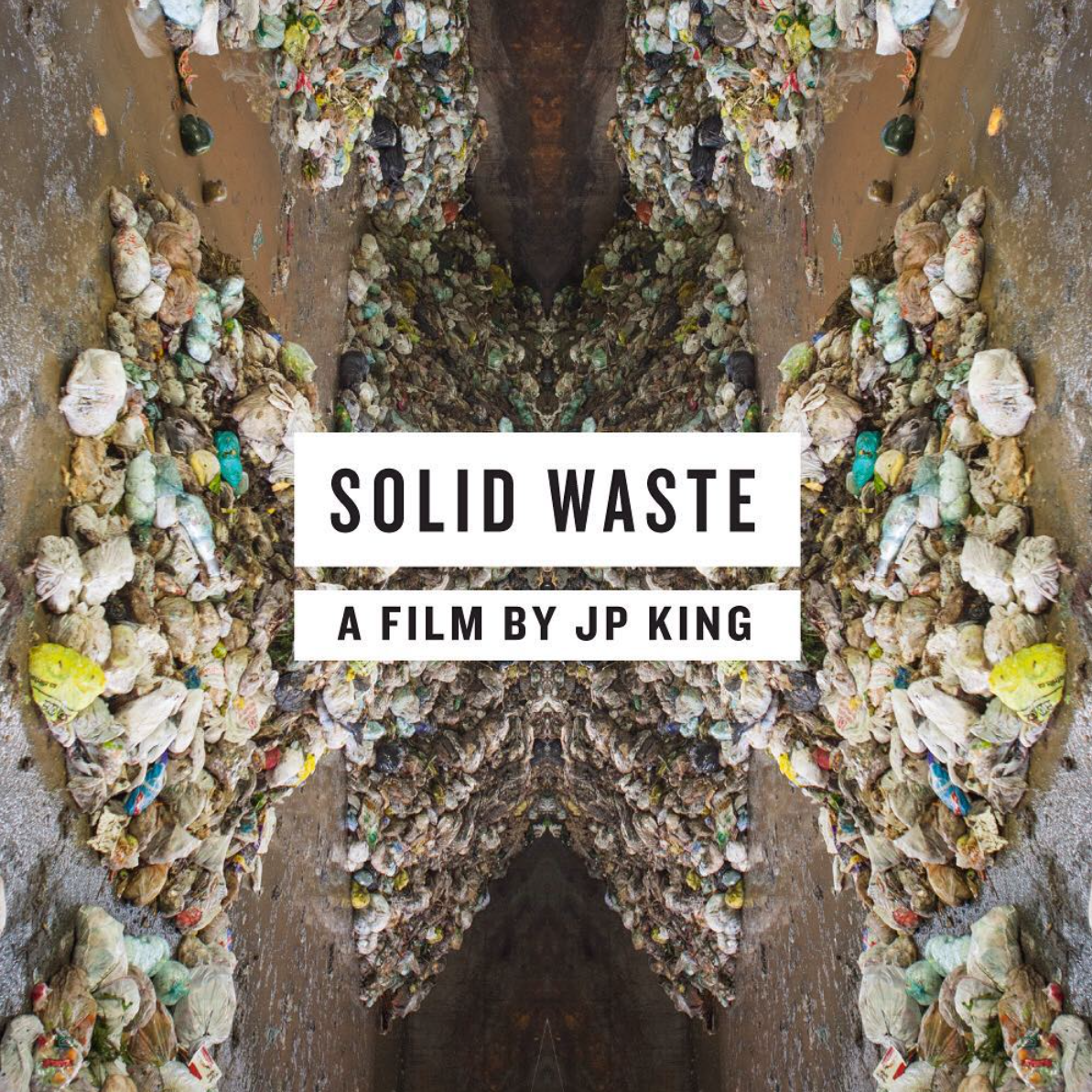 Image of large piles of solid waste, garbage bags and trash on the ground, with the title 'Solid Waste' and subtitle 'A film by JP King' displayed over it.