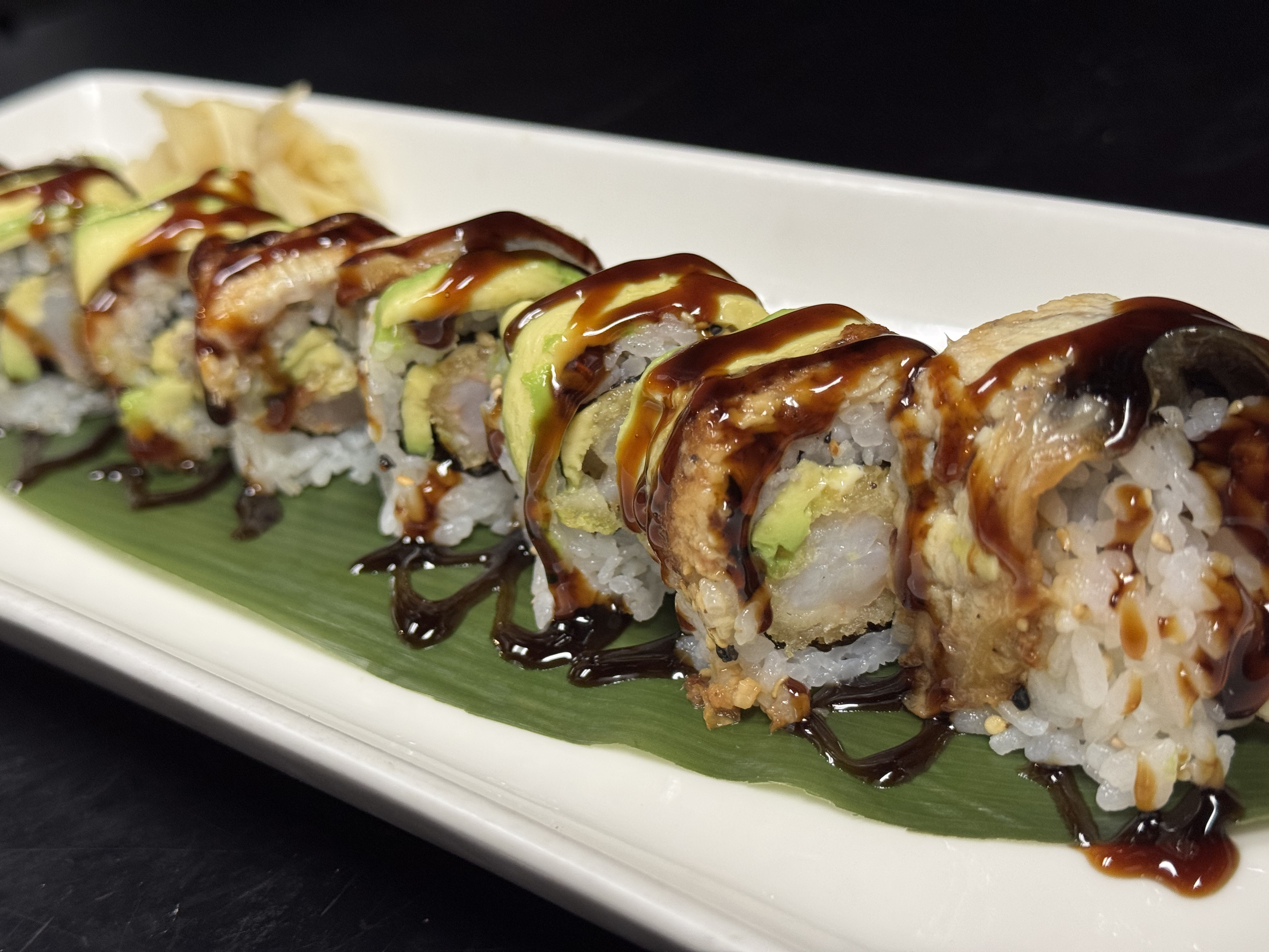 Dragon Roll - Sushi roll made of shrimp tempura, avocado & mayo topped with eel, avocado & eel sauce