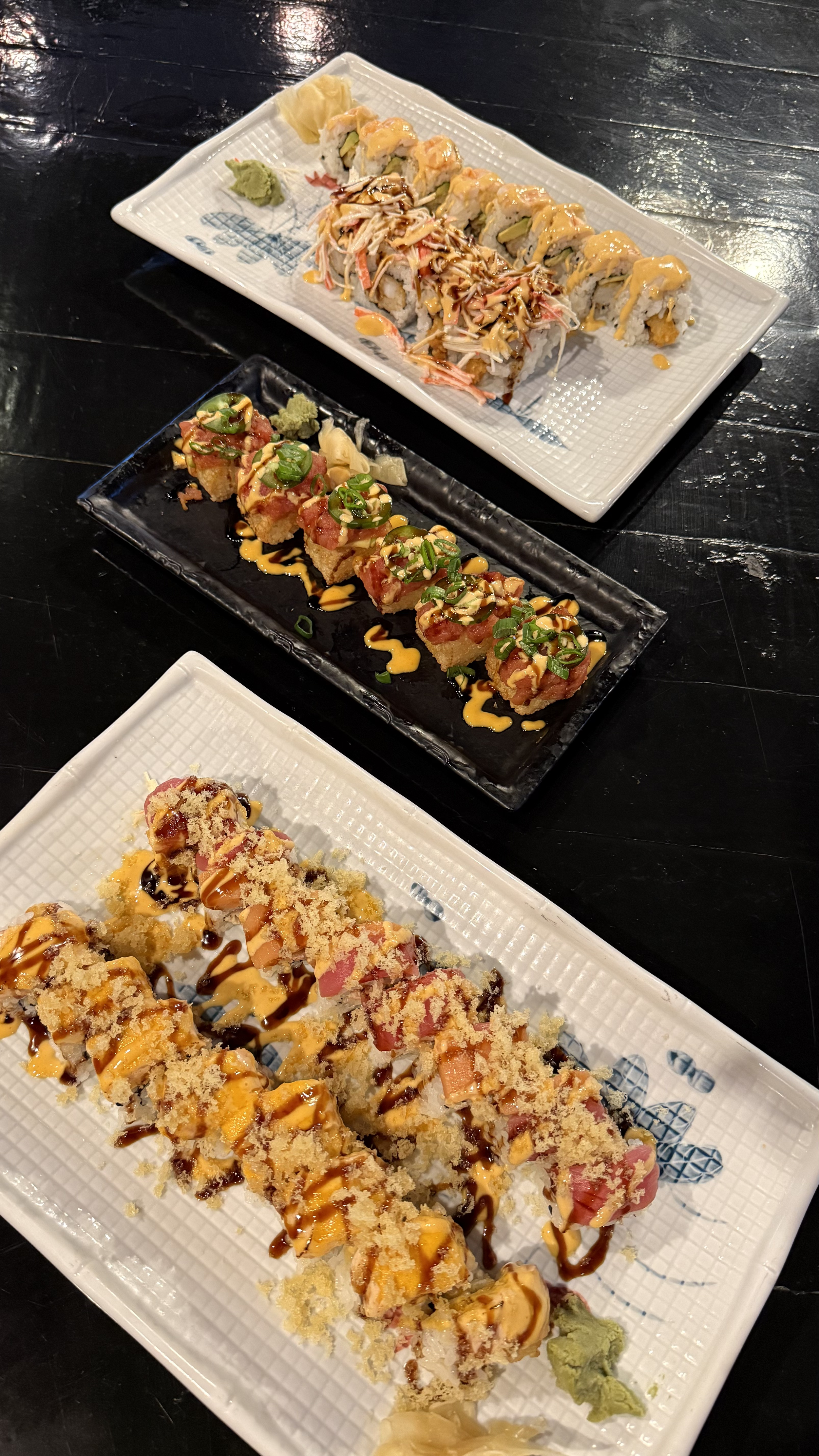 Spread of five sushi rolls - Tiger Roll, Willow Lane Roll, Crispy Chili Bombs, Monica Roll, Atomic Bomb Roll