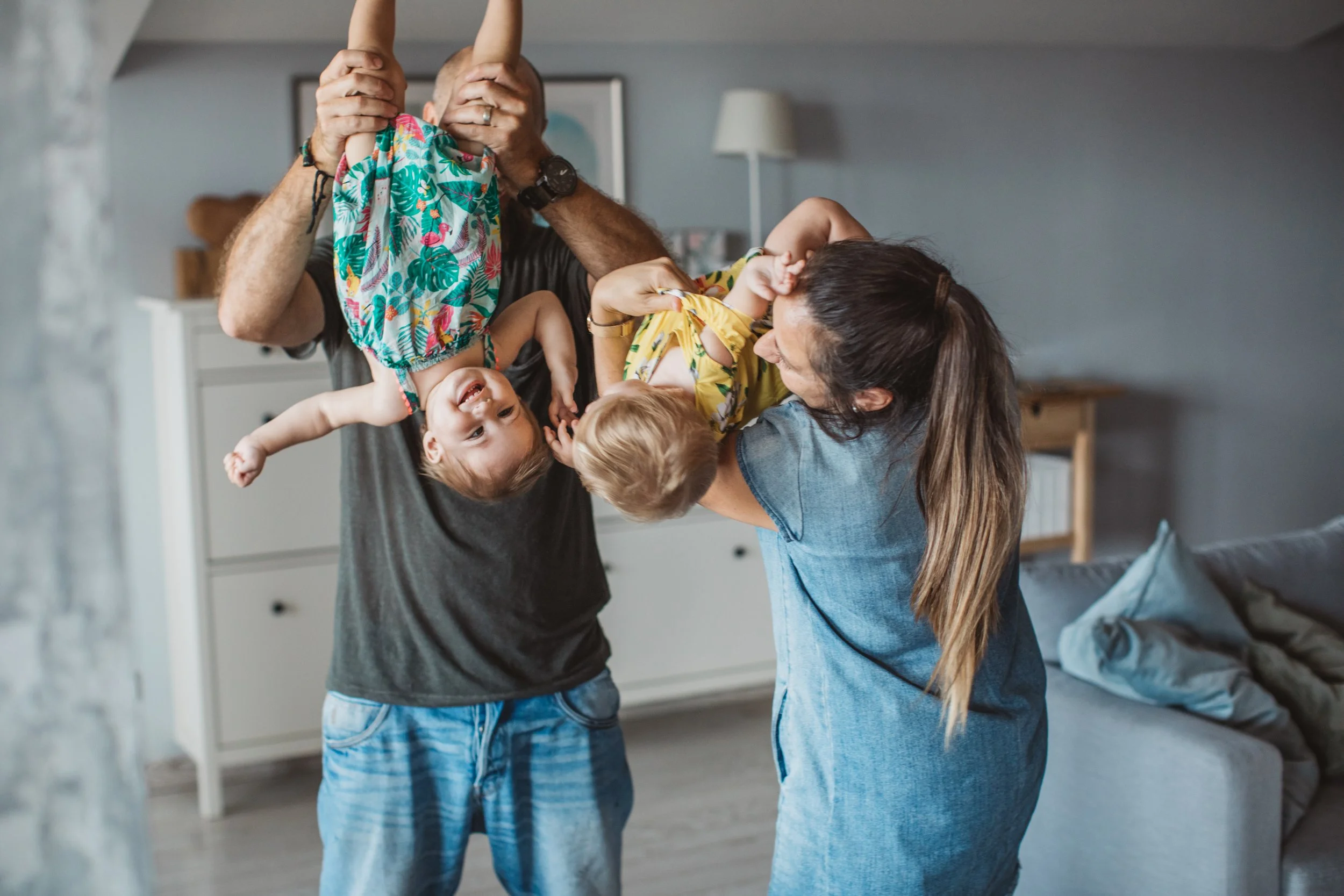 Parents playing with their two young children.