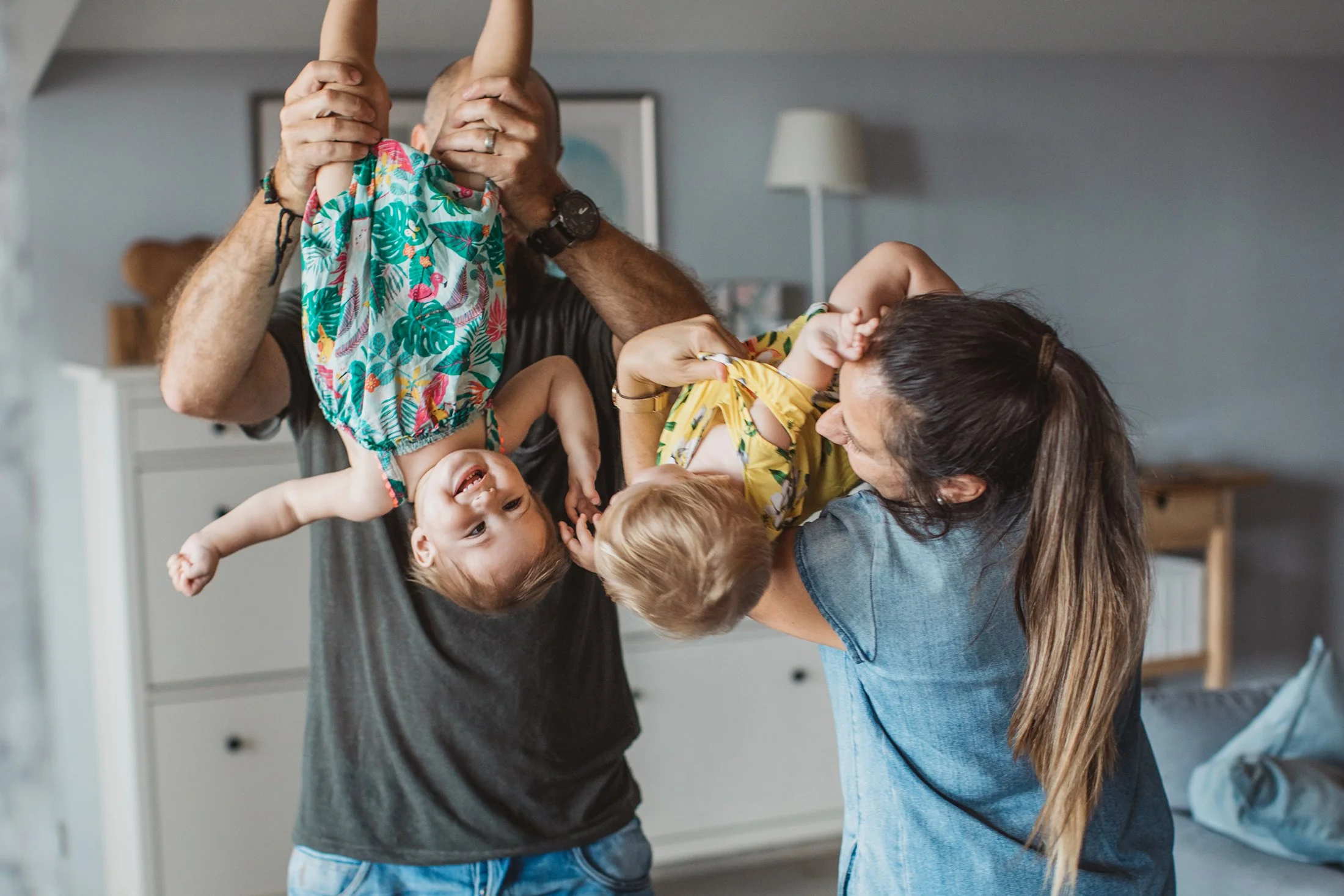 Parents playing around with their two young children.
