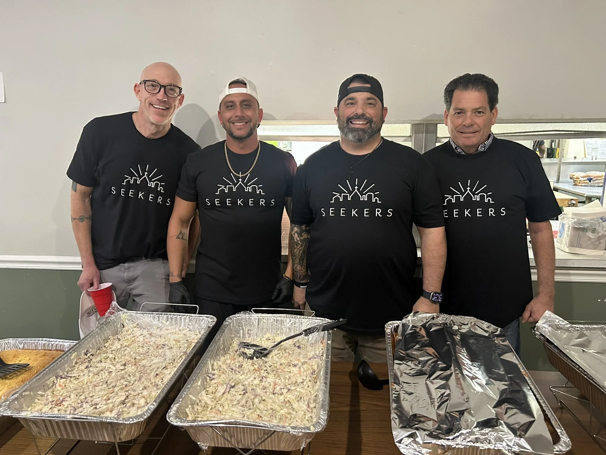 Volunteers wearing the New Seekers Ministry T-Shirts "Front"