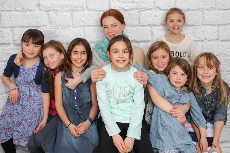 Lisa with group of birthday party attendees wearing their beaded creations