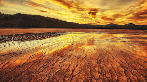 Sunset with clouds over a dry desert landscape