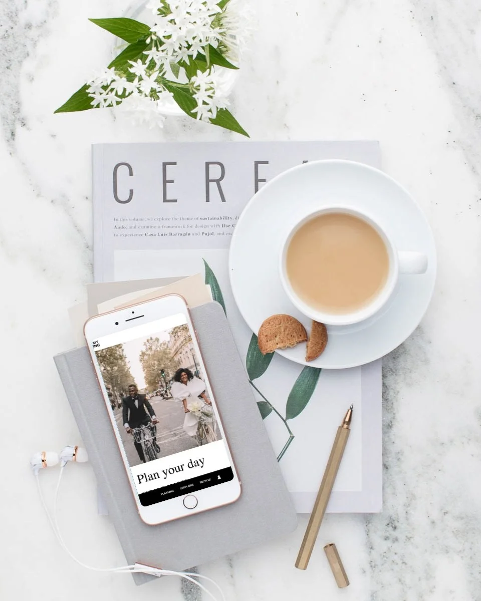 Flat image of a Cereal magazine, iphone and tea cup. Iphone screen showing a wedding blog