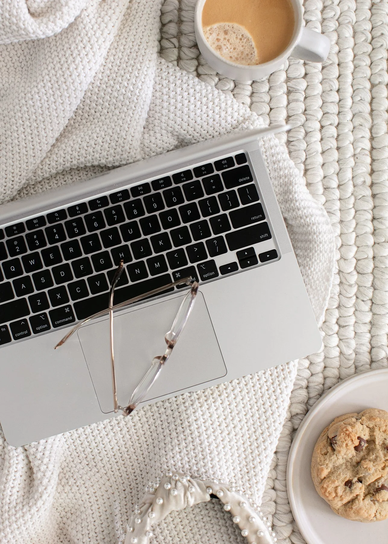 Laptop laid on the floor by a small business owner. Tea and biscuits next to it.