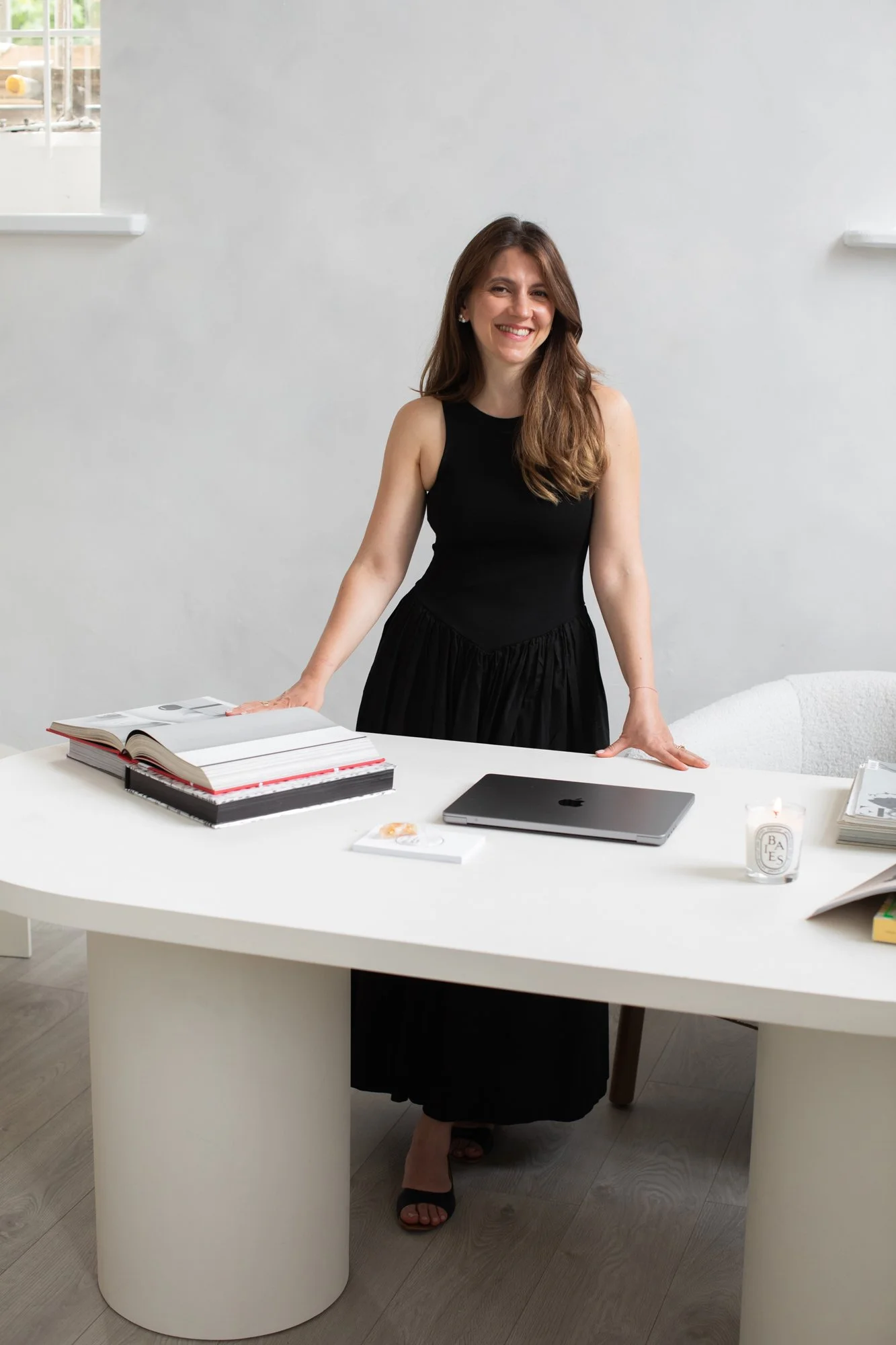 Wedding SEO expert, Nergis Yuksel, standing behind her desk and smiling