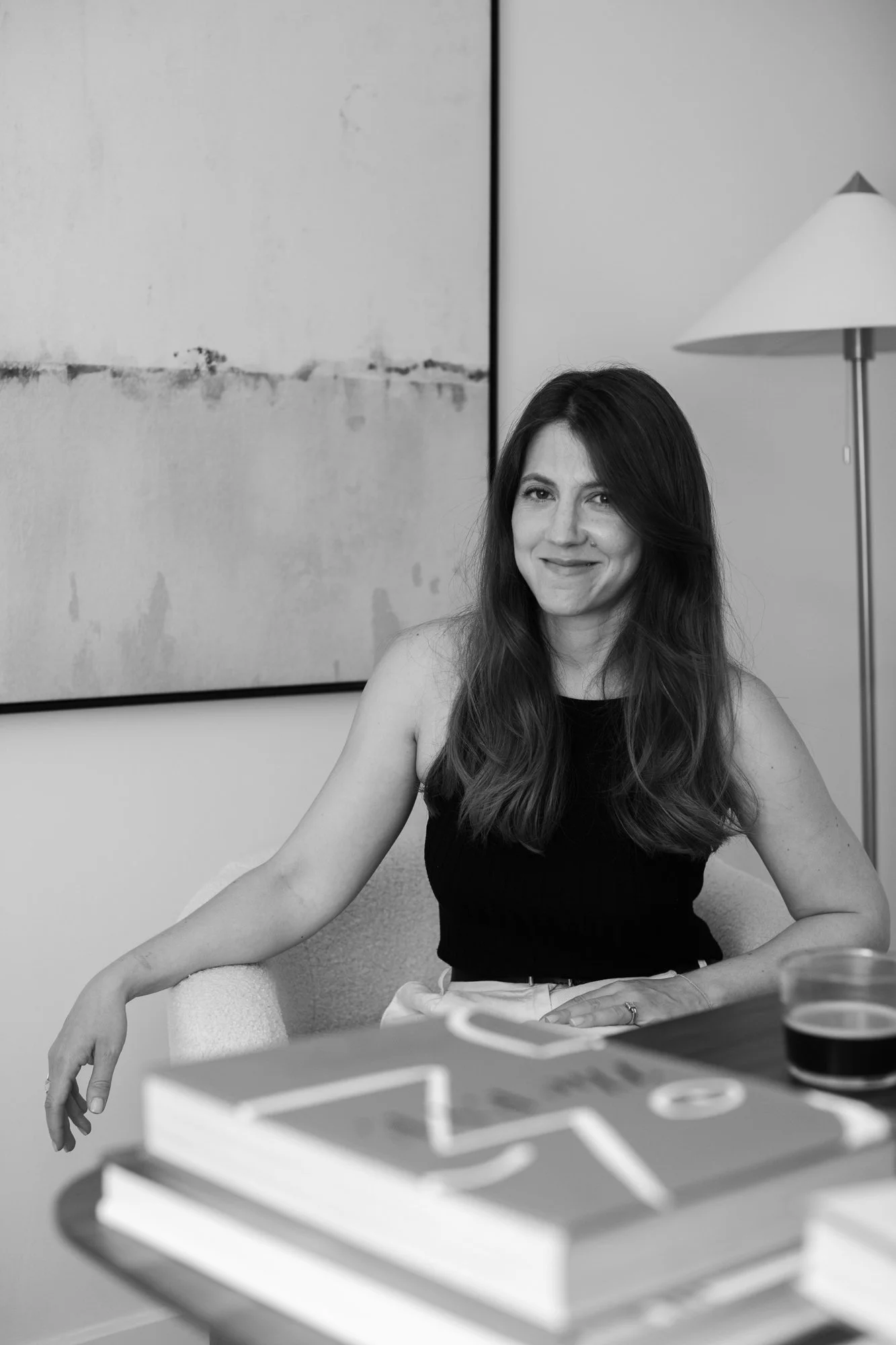 Black and white portrait of a wedding SEO expert Nergis Yuksel, sitting at her desk