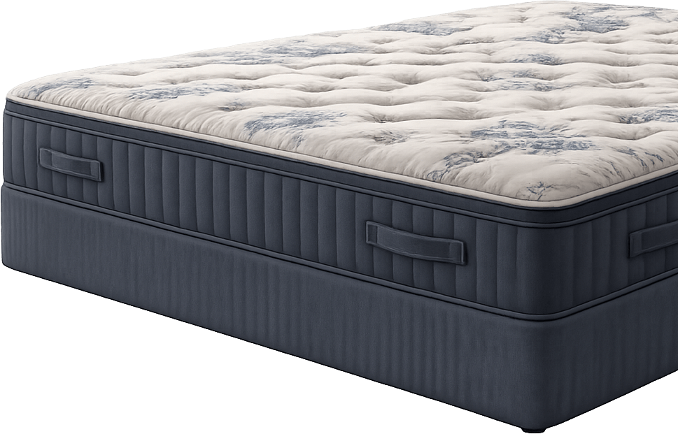 A close-up of a queen-sized mattress with a blue fabric base and a white and gray marbled patterned mattress top.