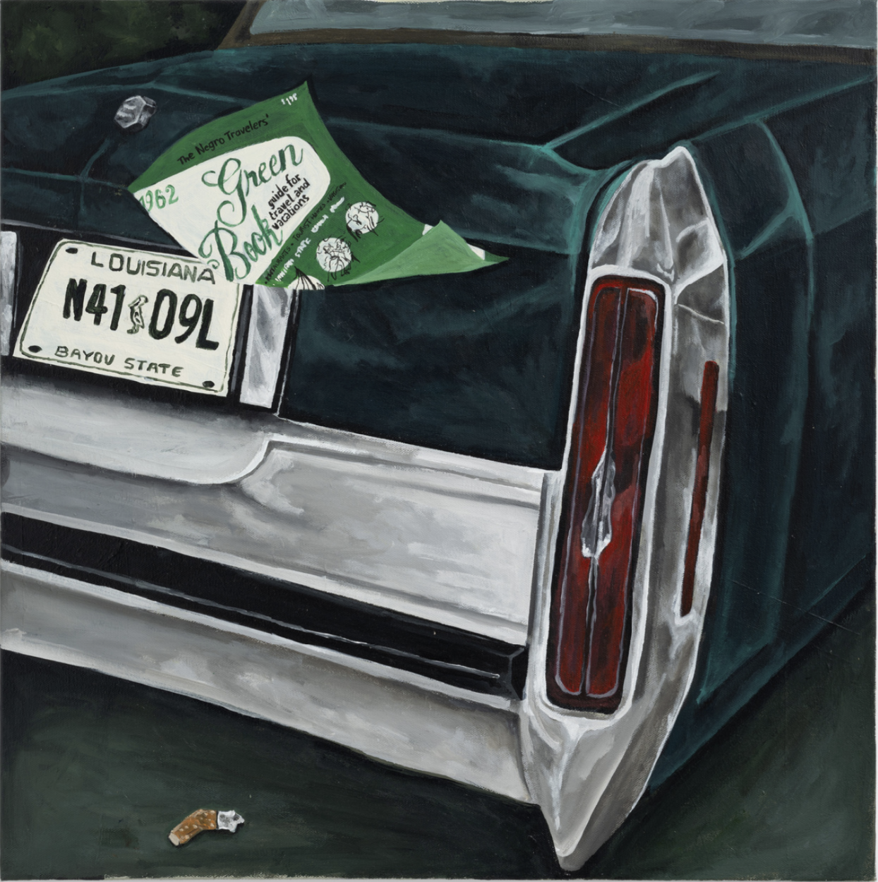 Close-up of the rear of a vintage green car with a Louisiana license plate and a green pamphlet titled 'Green Book' resting on the trunk, with a small object on the ground nearby.