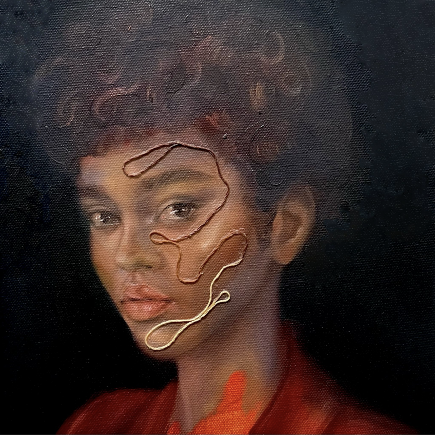 Portrait of a woman with curly hair and wearing a red garment, with metallic wire art on her face.