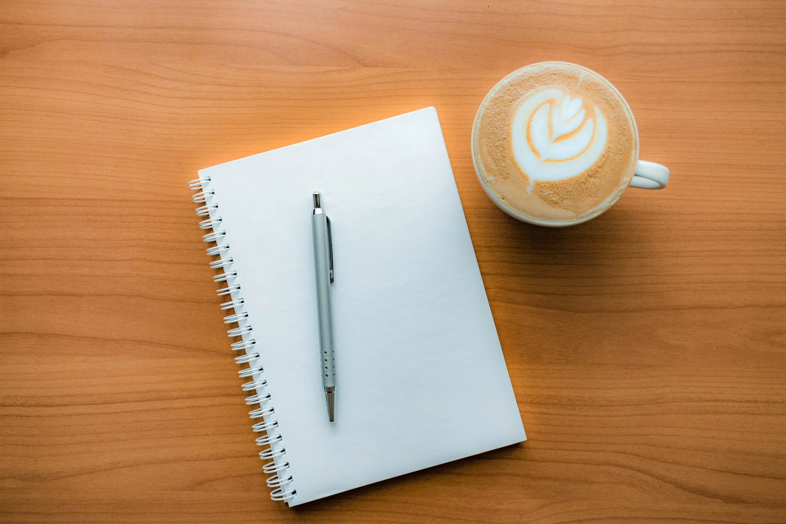 Notepad, pen and coffee