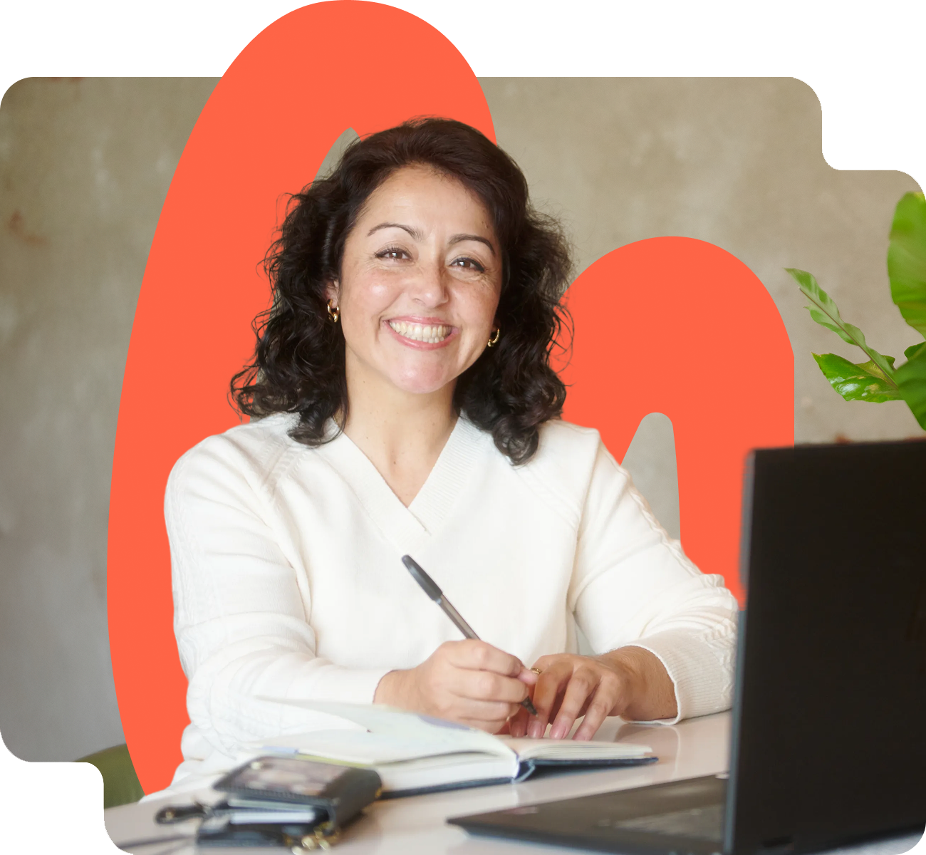 Ana smiling while writing in her notebook at a desk, showcasing a healthcare startup CFO providing fractional CFO healthcare and biotech financial services | Intellichoice Solutions } mission driven founders