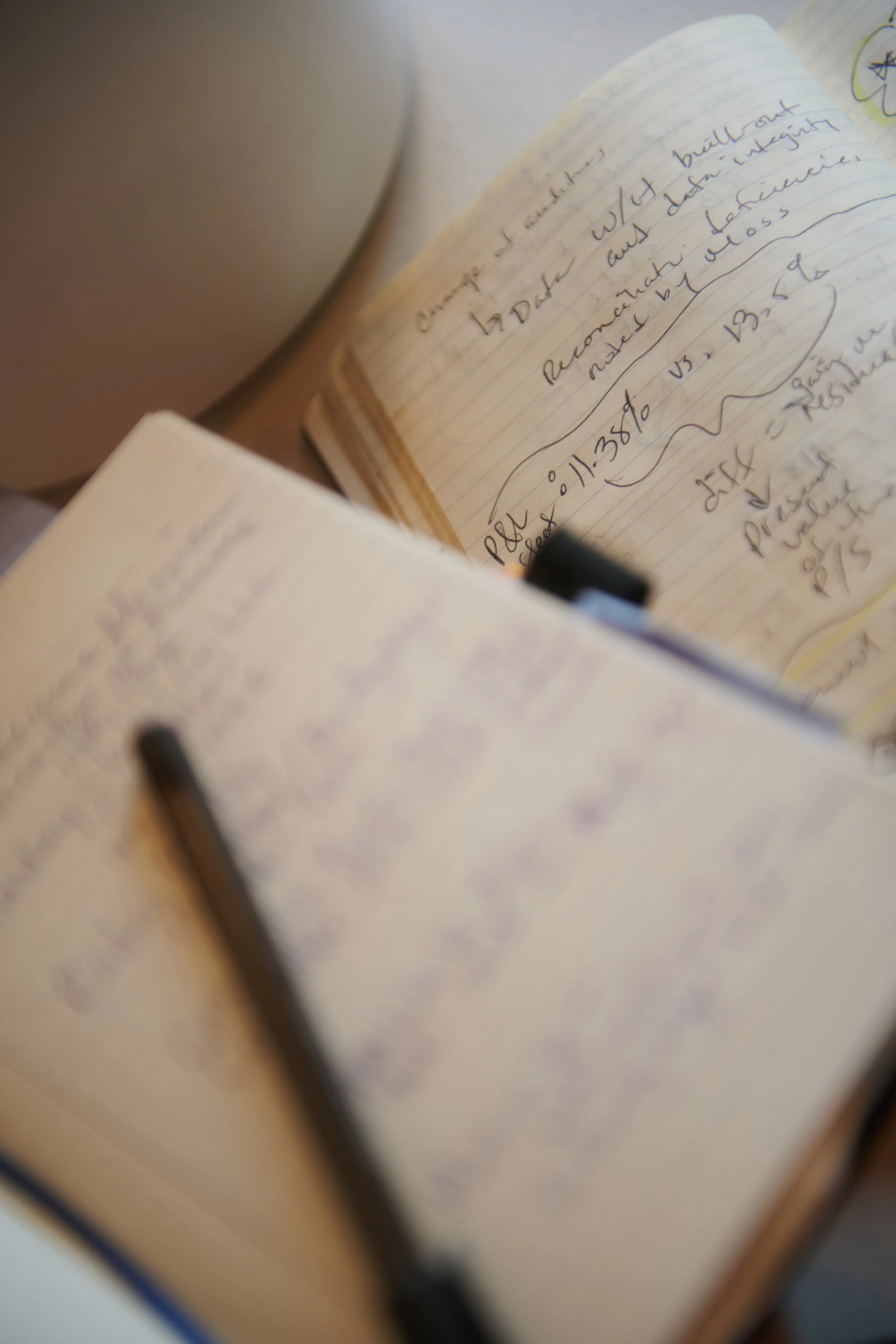 Close-up of handwritten financial notes in a notebook, representing structured financial implementation and infrastructure setup for healthcare startups | Intellichoice Solutions