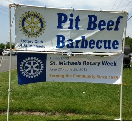 Banner promoting Pit Beef Barbecue by the Rotary Club of St. Michaels, celebrating Rotary Week June 22-28, 2015, with the slogan 'Serving the Community Since 1939'.
