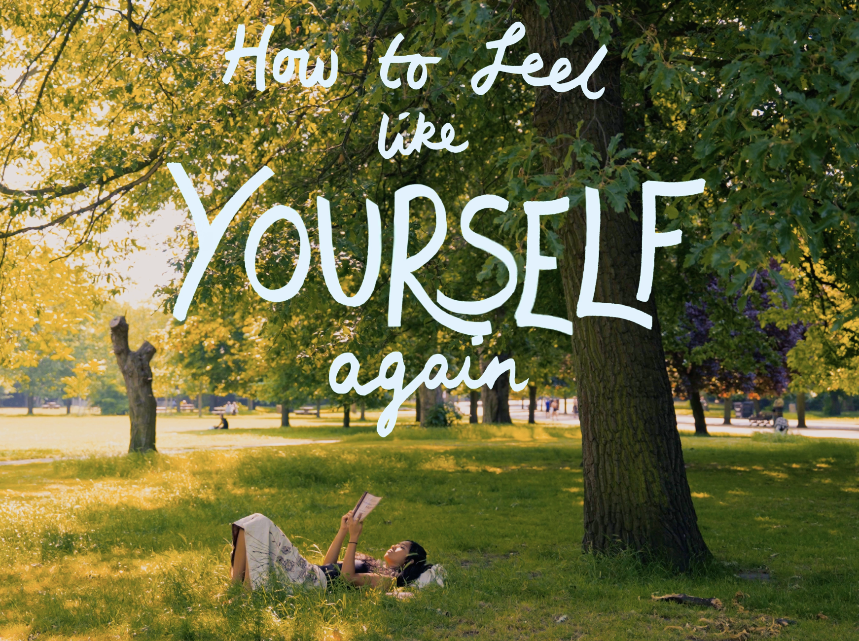 A woman laying on grass in a park, reading a book, surrounded by green trees with sunlight filtering through. Overlaid text reads, "How to Feel like YOURSELF again."