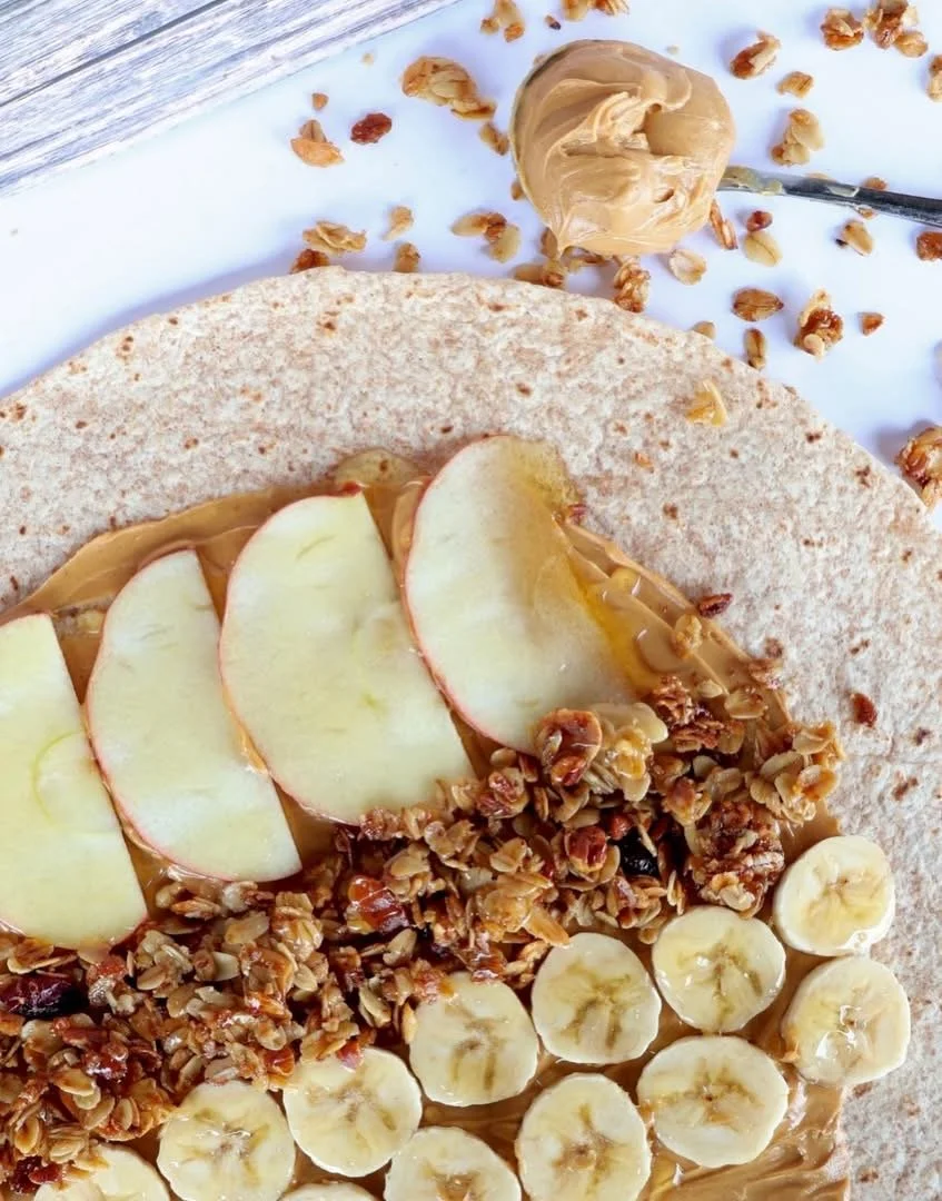 The peanut butter warp is packed with bananas, apple slices, granola, and peanut butter.