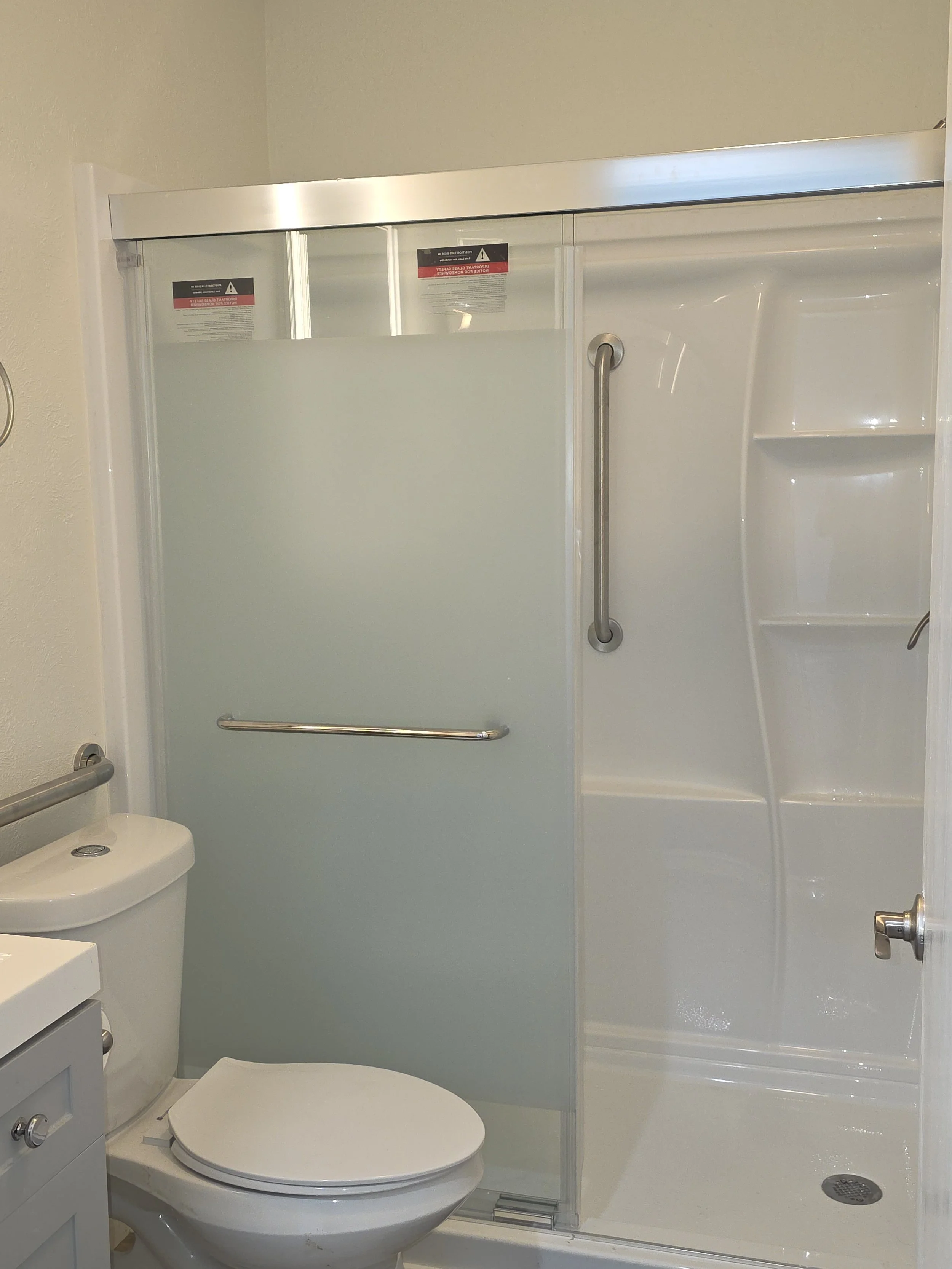 Senior-accessible walk-in shower with 2.5-inche step-in threshold, non-slip flooring, and safety grab bars.