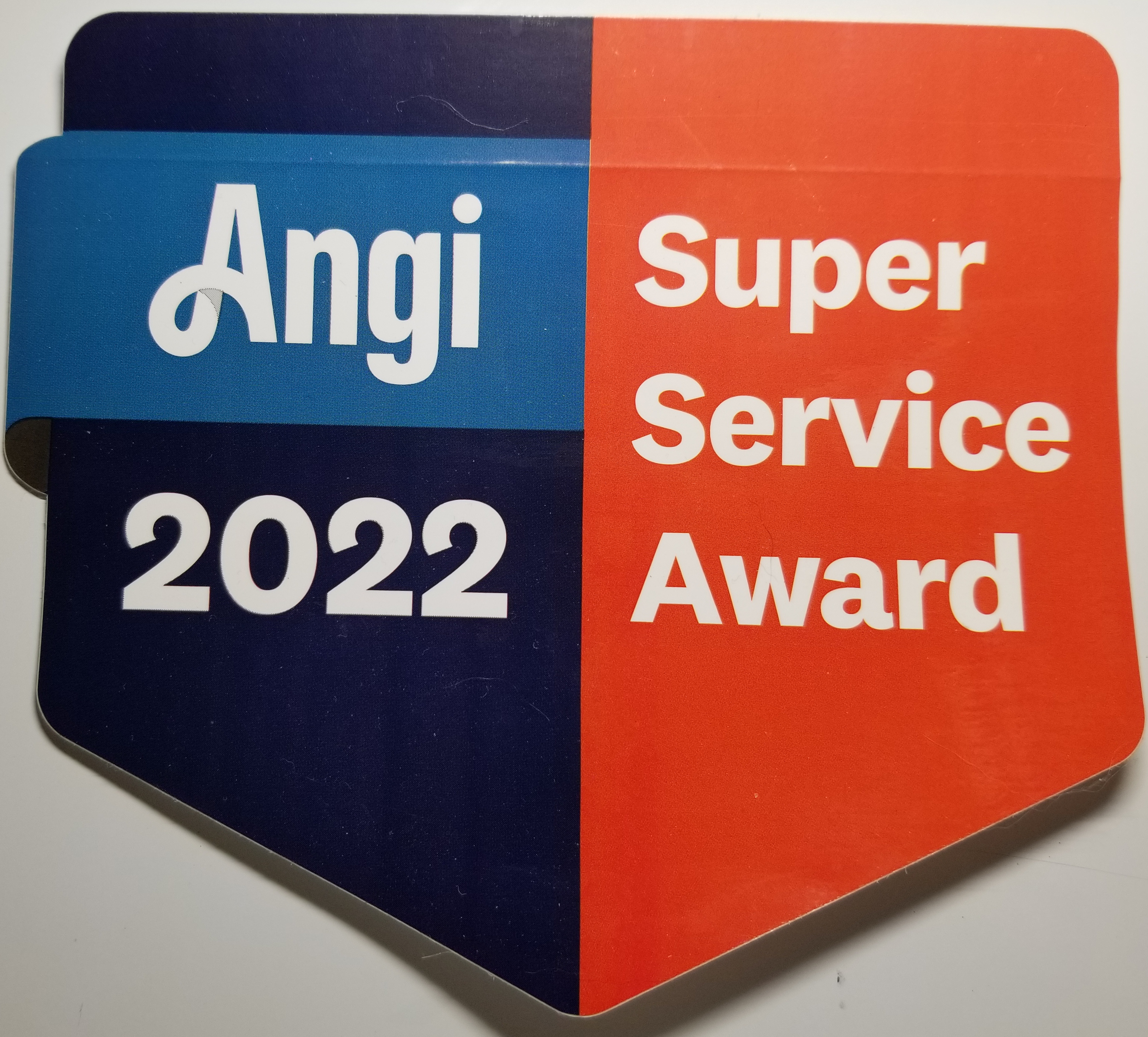 A badge showing the name 'Angi', the year 2022, and the words 'Super Service Award' in white text on a blue and orange background.