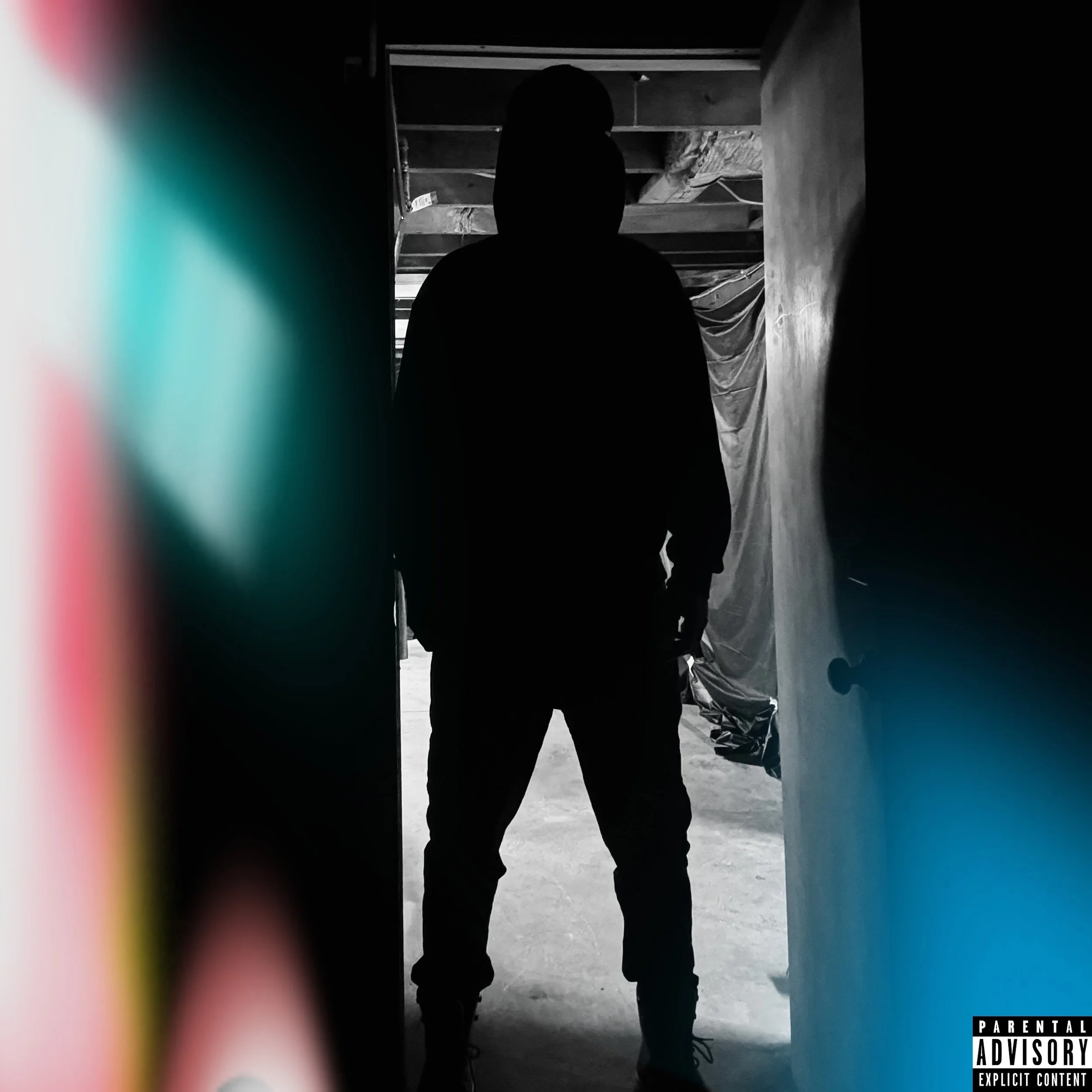 A silhouette of a person wearing a hoodie, standing in a dark, narrow space with a partially open door behind them, with a blurry colorful object in the foreground and some plastic sheeting in the background.