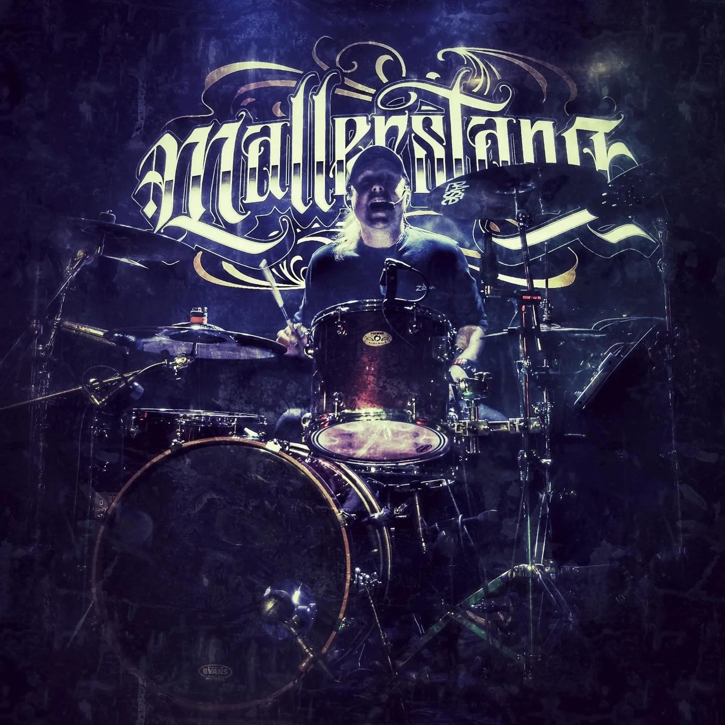 A drummer playing a drum set in front of a backdrop with the name 'Metal Saint' at a concert.