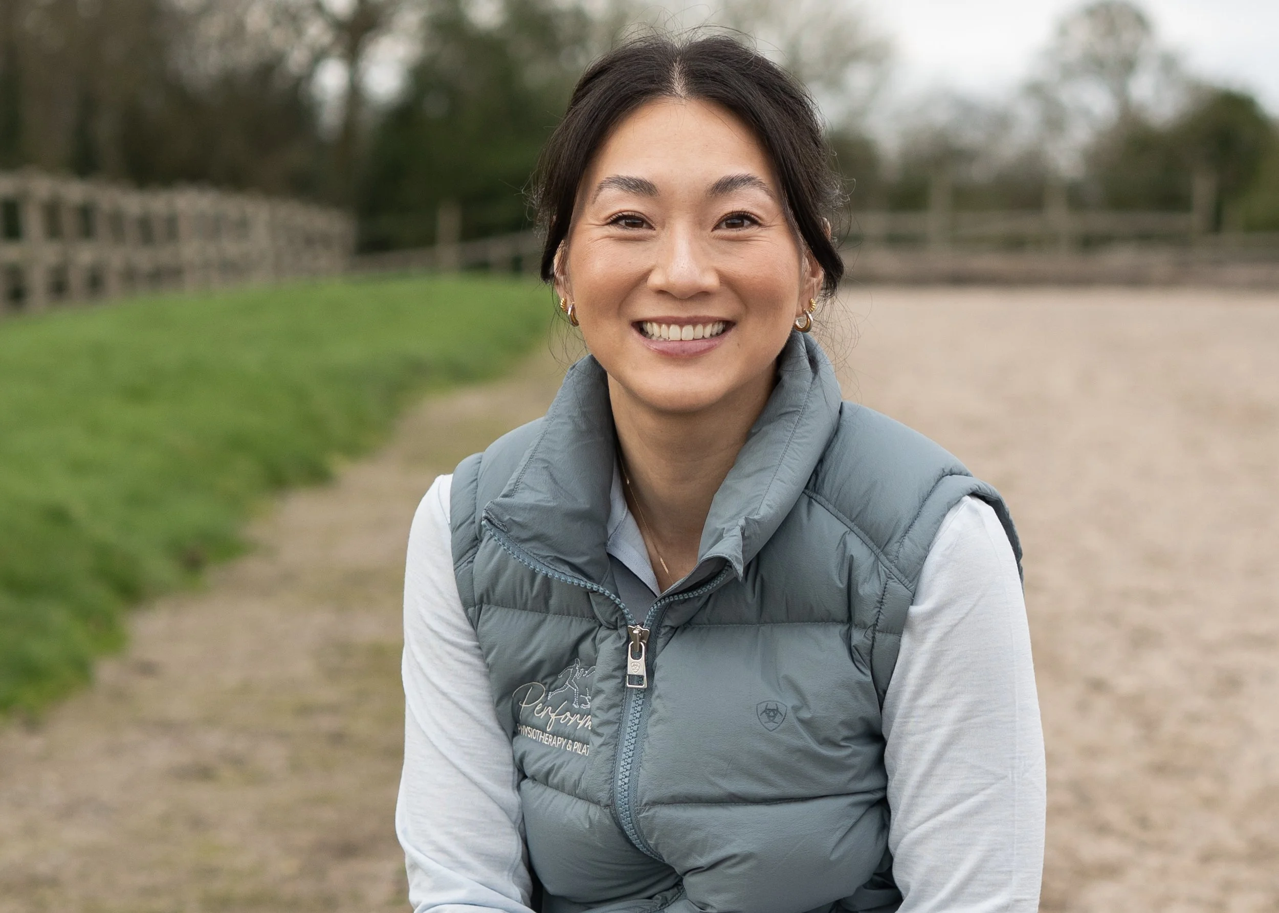 Woman sat smiling outside