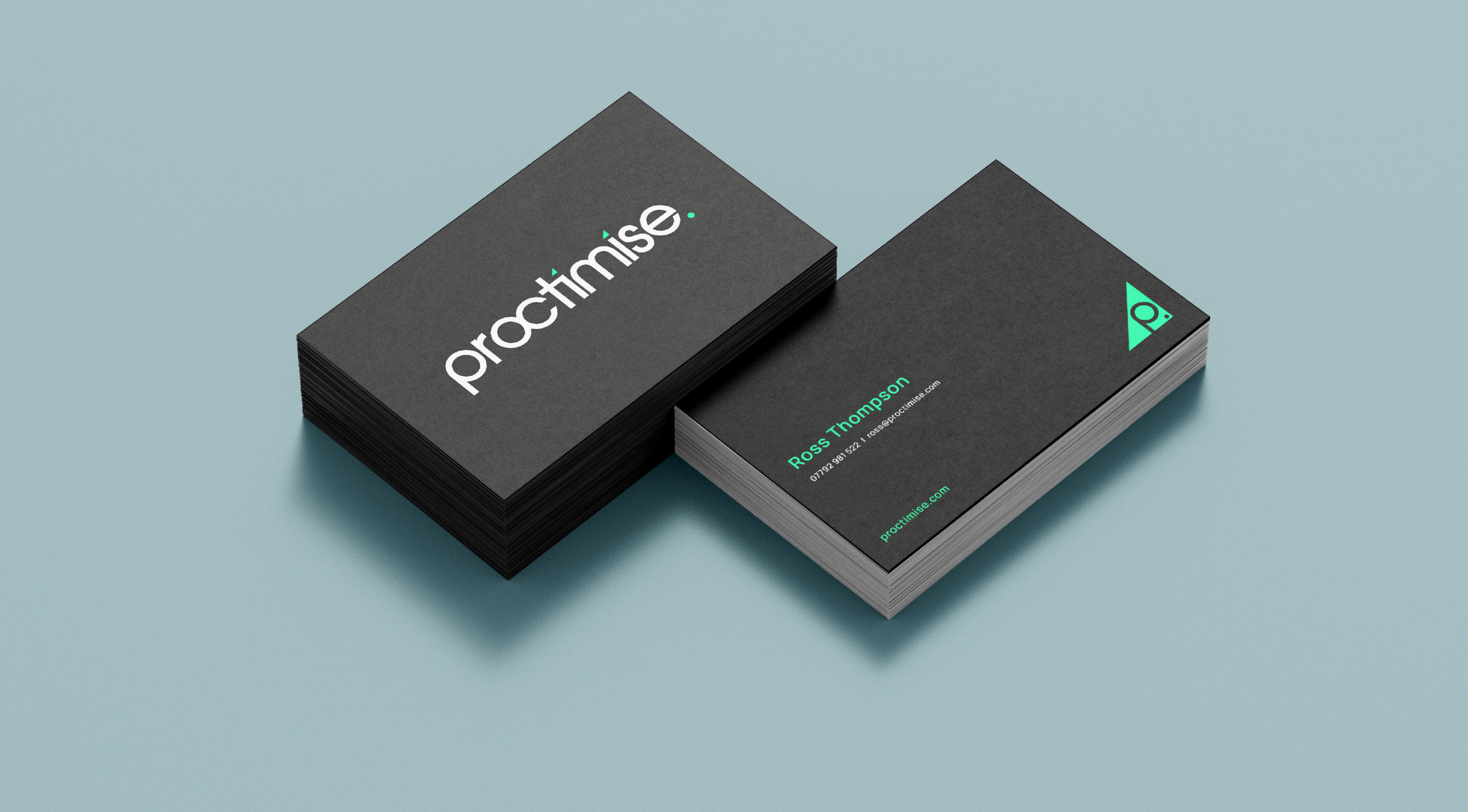 Close-up of stacks of business cards on a light blue background, featuring the logo and contact information for Practimise and Ross Thompson.