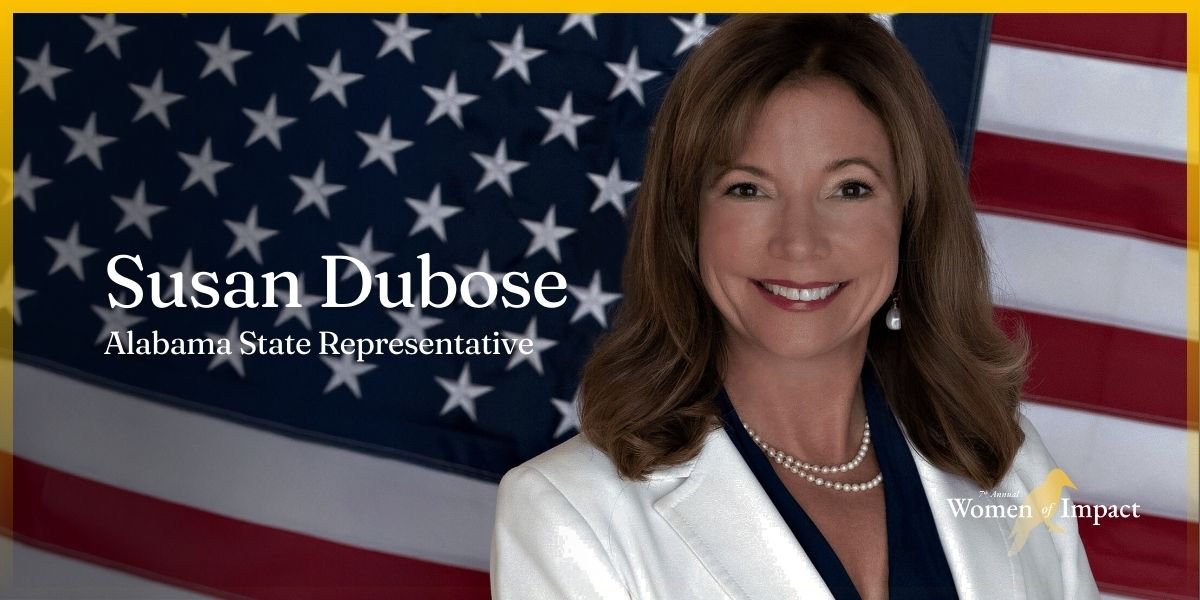 A woman with shoulder-length brown hair smiling in front of an American flag, wearing a white blazer, pearl necklace, and pearl earrings, with text overlay of her name and title.