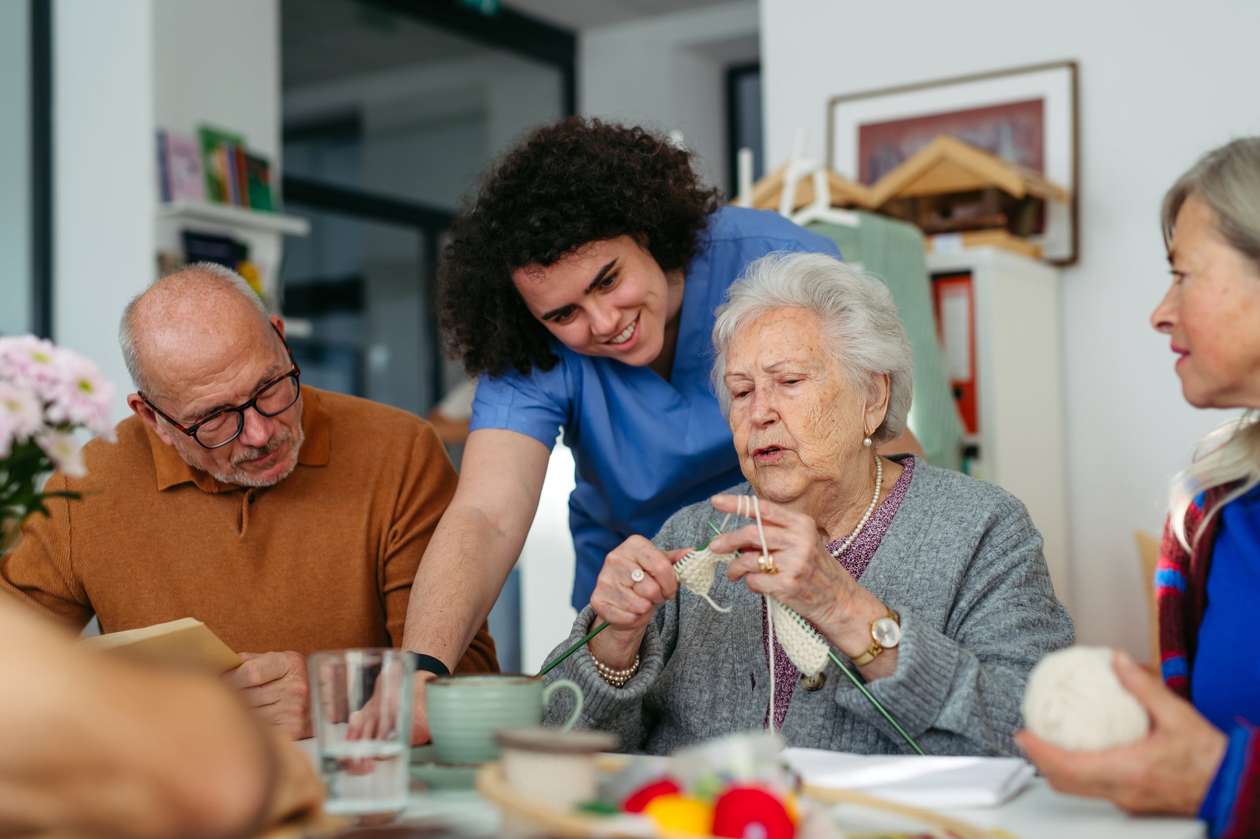 Older adults participating in a group knitting activity.