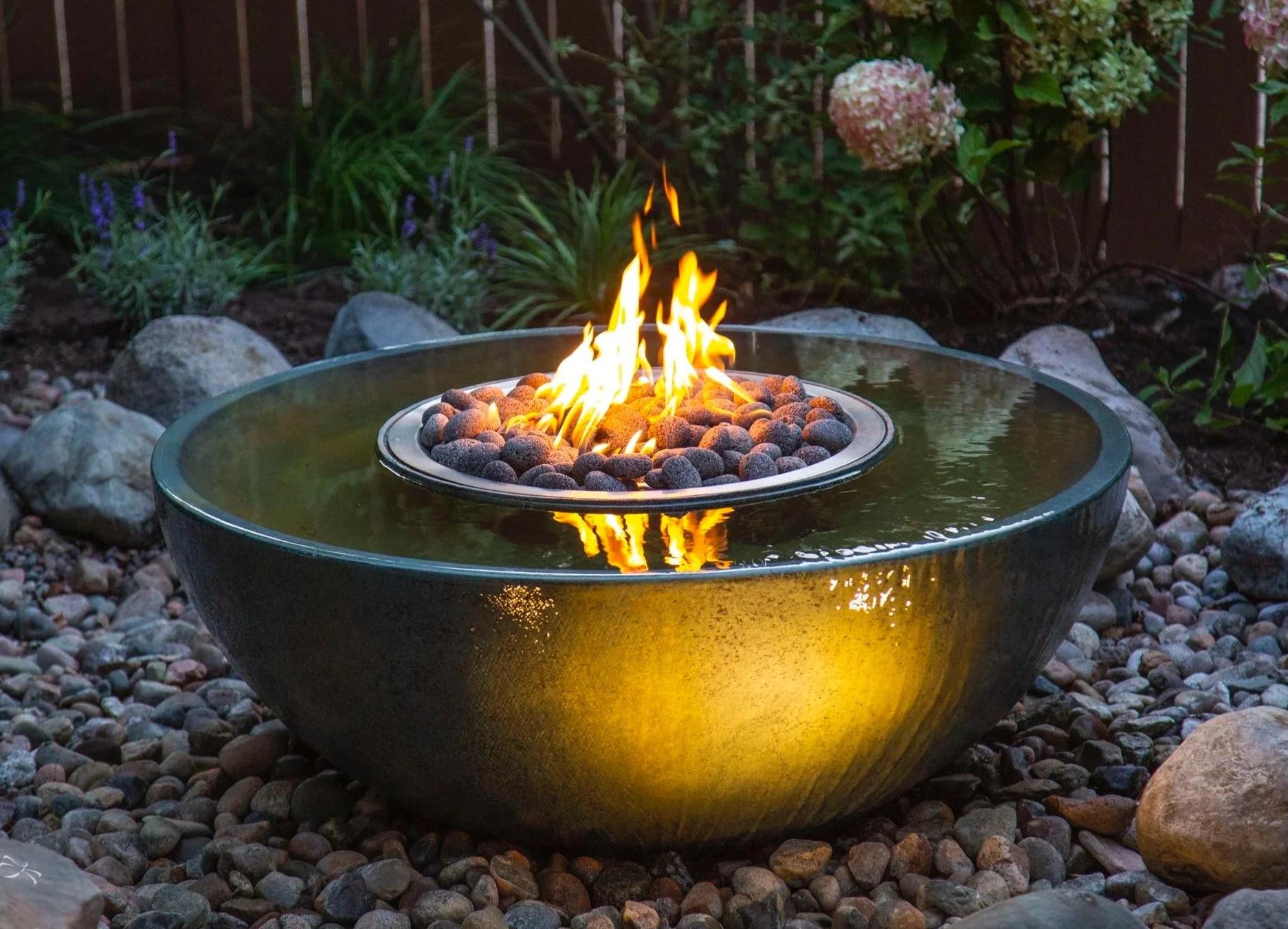 Water feature spillway bowl with fire.