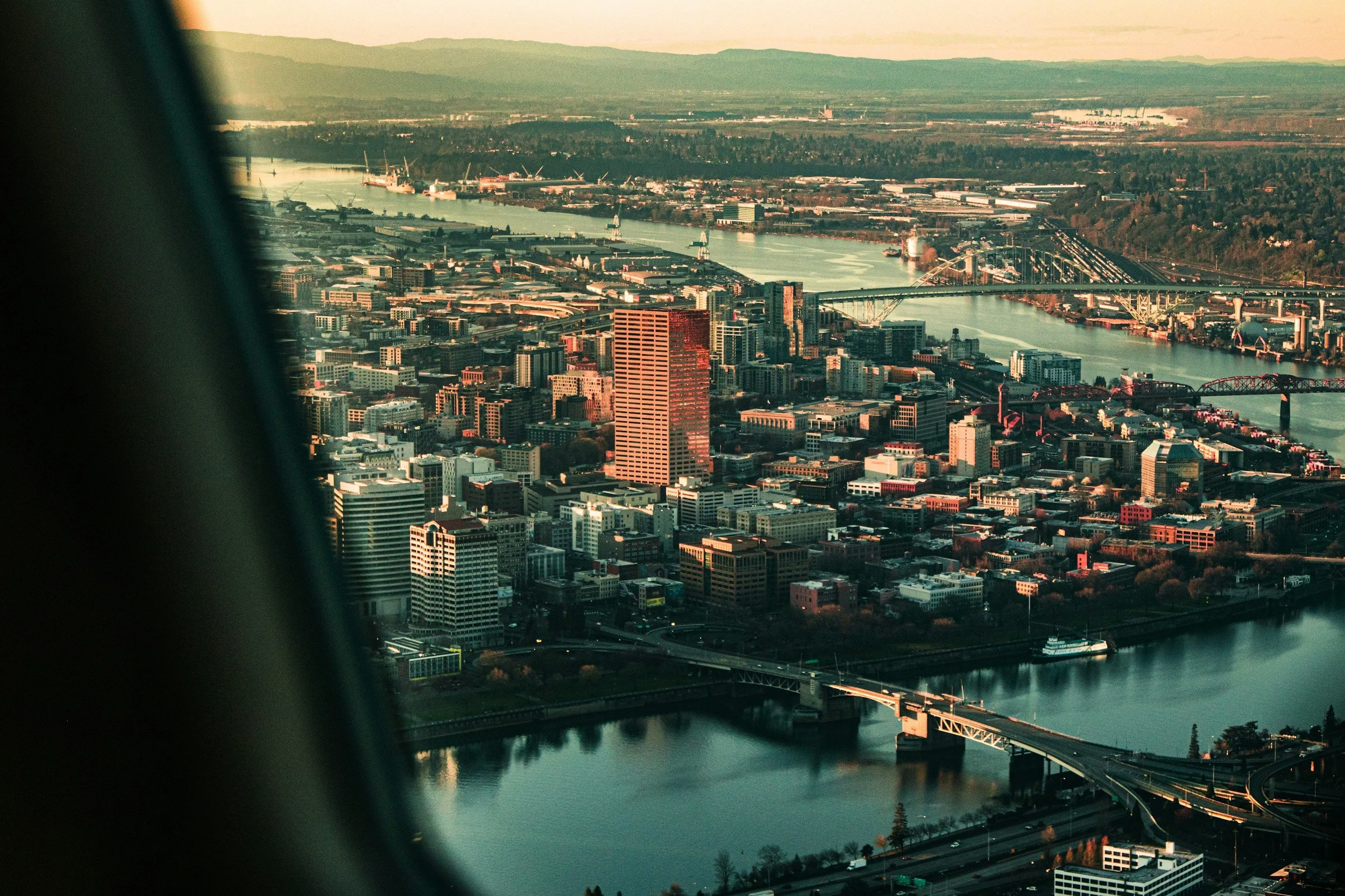 Portland Oregon aerial skyline with Willamette River bridges and Pearl District commercial real estate neighborhood