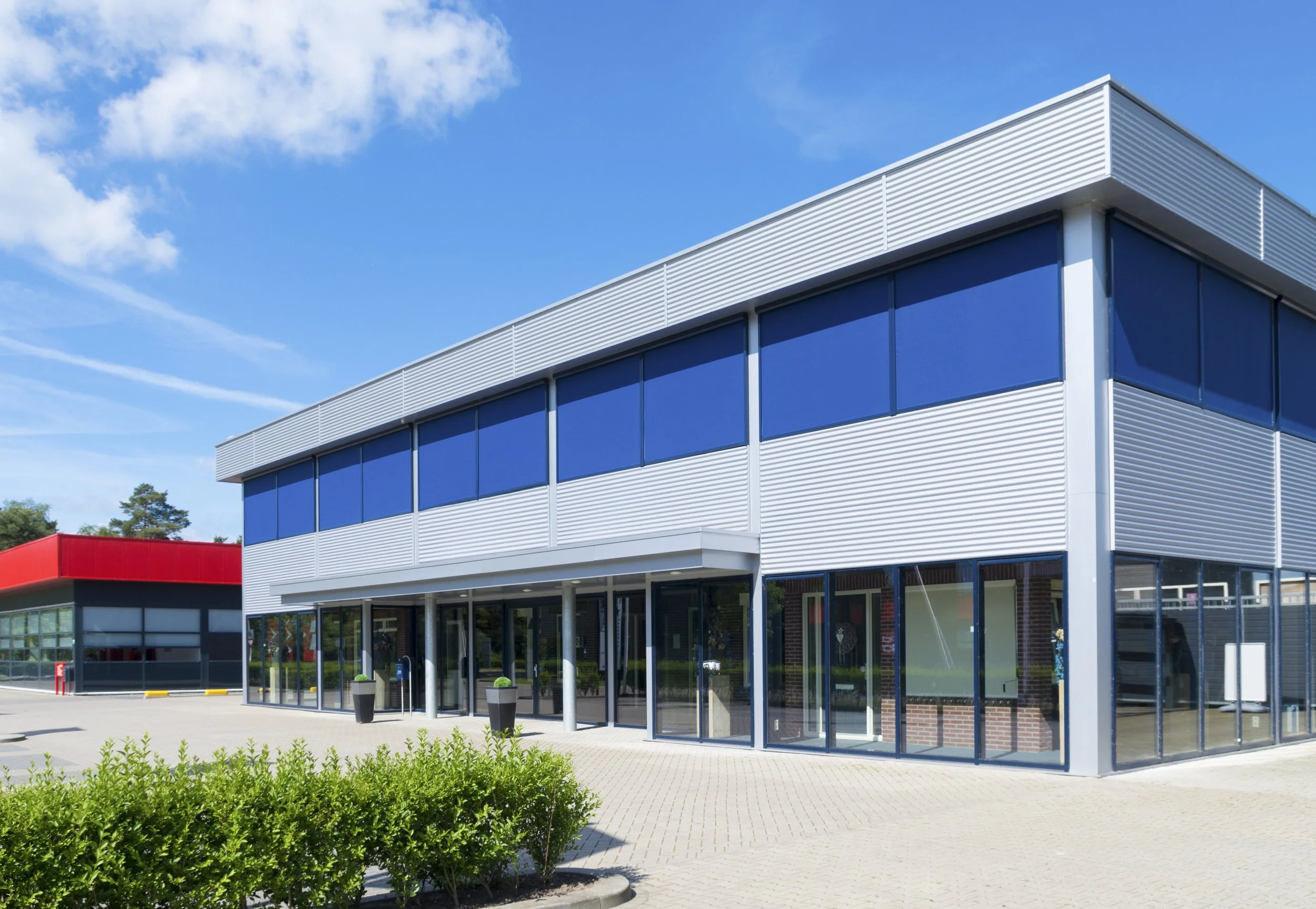 Modern flex and R&D commercial building with metal siding and blue-tinted glass windows in Portland Sunset Corridor