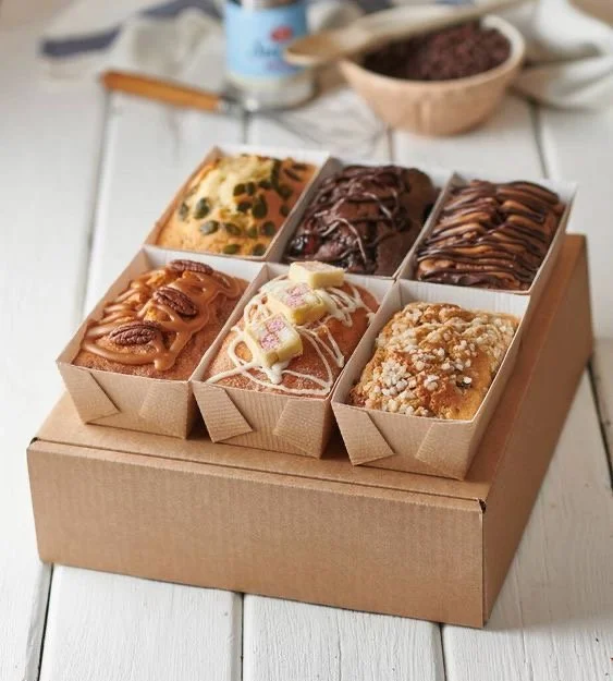 Six banana bread minis in a box.