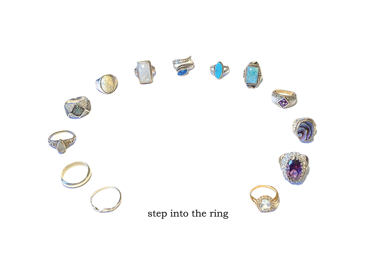 A window display for a luxury store featuring a collection of rings, categorized by layers of information, shown in the shape of a ring, with the words "step into the ring".