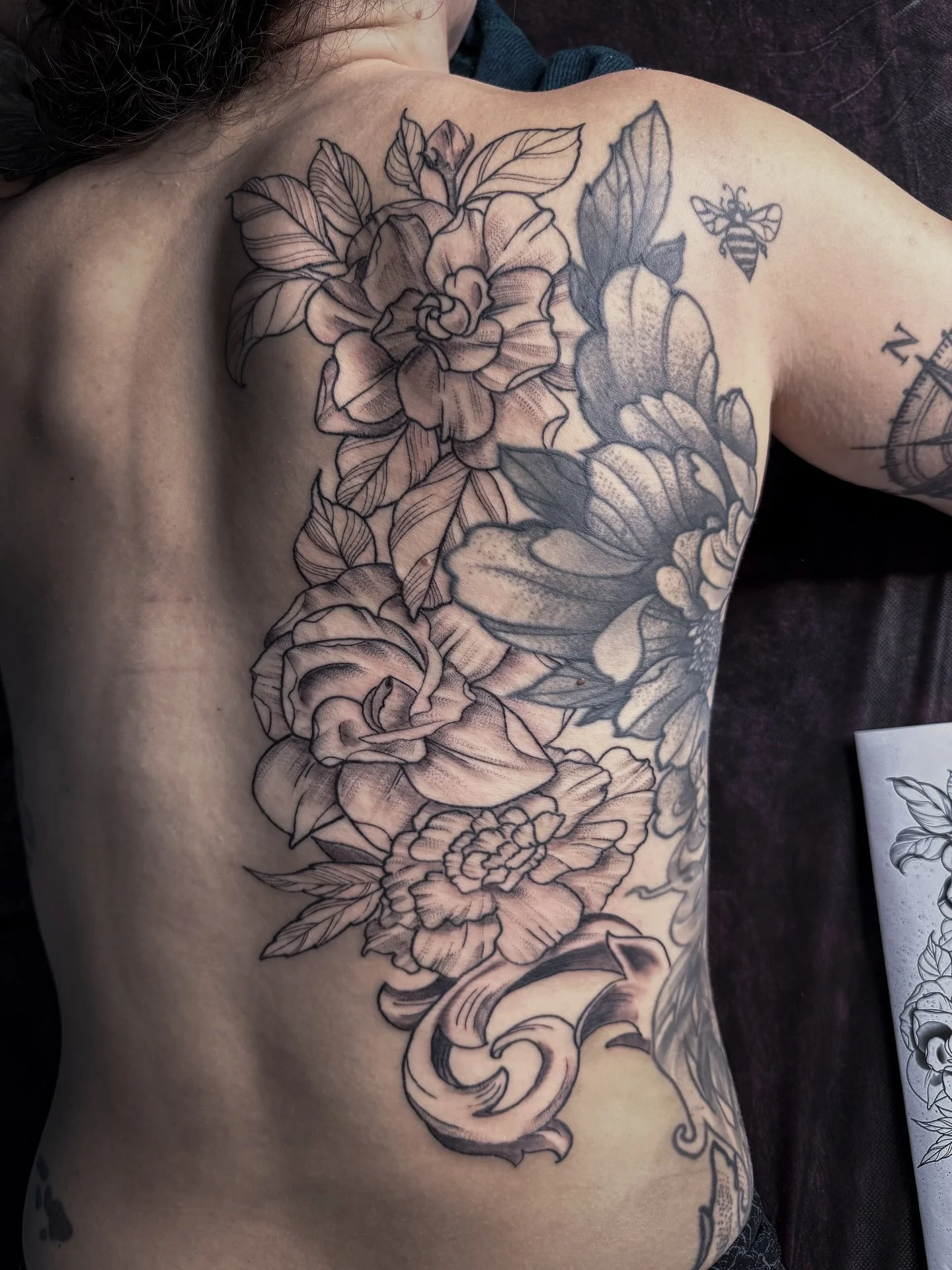 Kate came back after the first linework session to finish this one up with some shading. We added on to an existing tattoo, not done by me, to continue the florals. Eventually we are going to add some filigree to her lower back swirling to the outsid