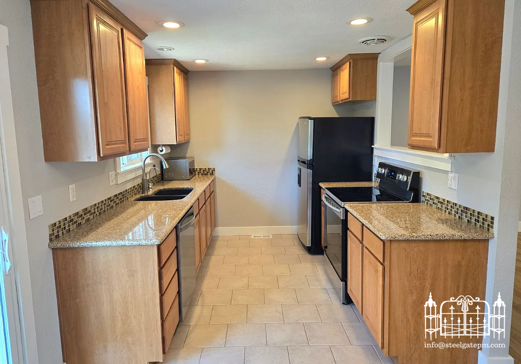 Kitchen with wooden cabinets, granite countertops, black appliances, and tiled floor.