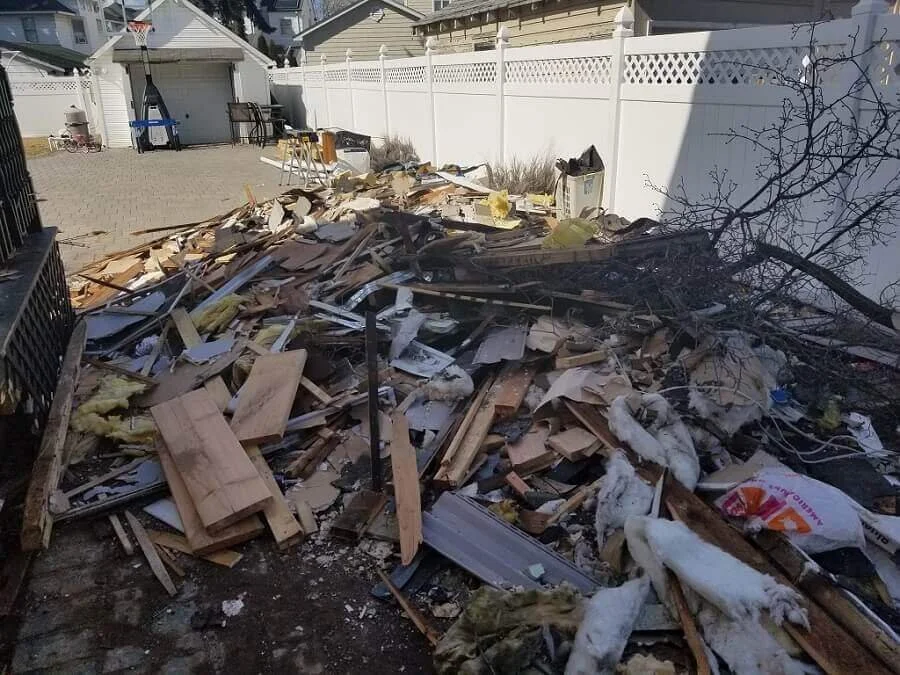 Construction, insulation, and debris in a backyard.