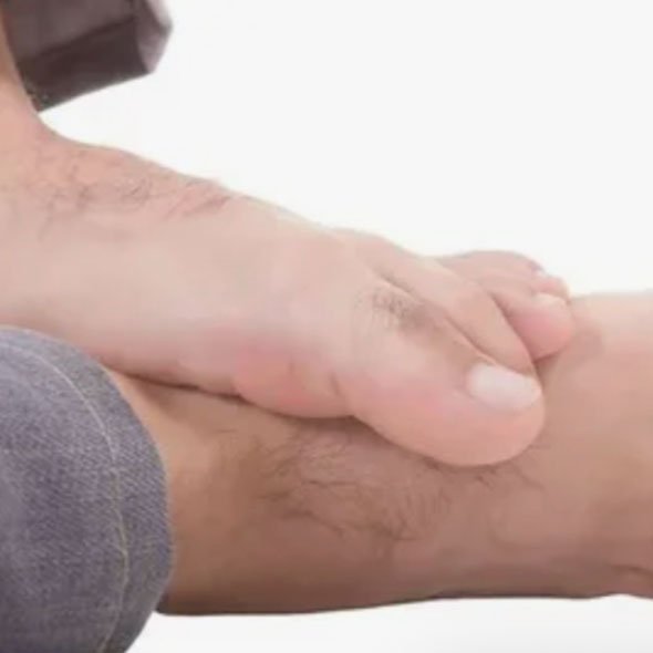 Close-up of a person's hand gripping their calf muscle.