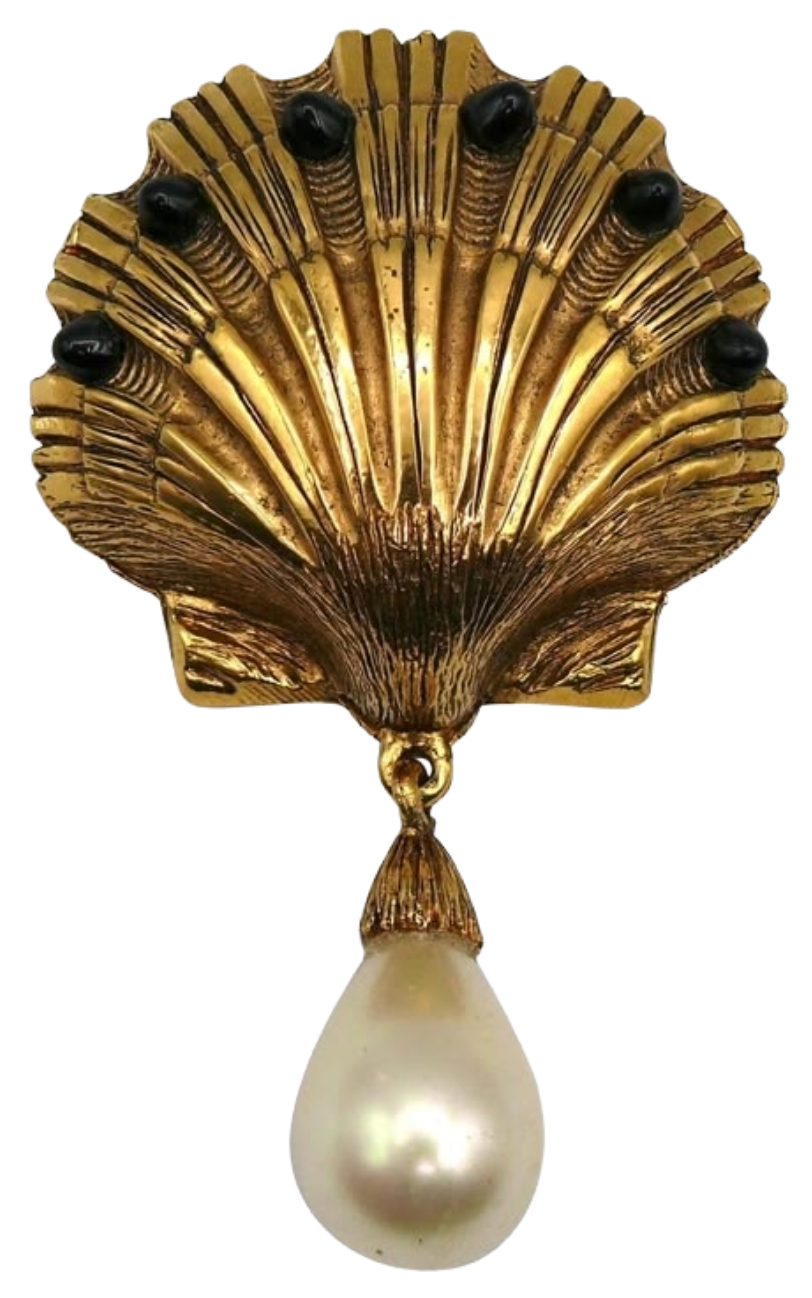 A decorative gold shell with a large pearl hanging from the bottom.