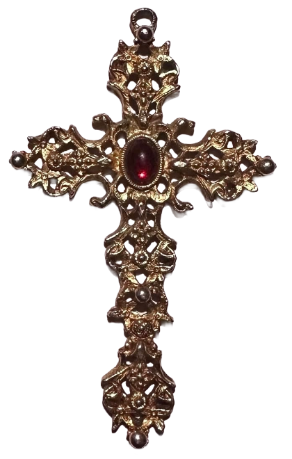 An ornate silver cross pendant with intricate designs and embedded gemstones, featuring a large red gemstone at the center.
