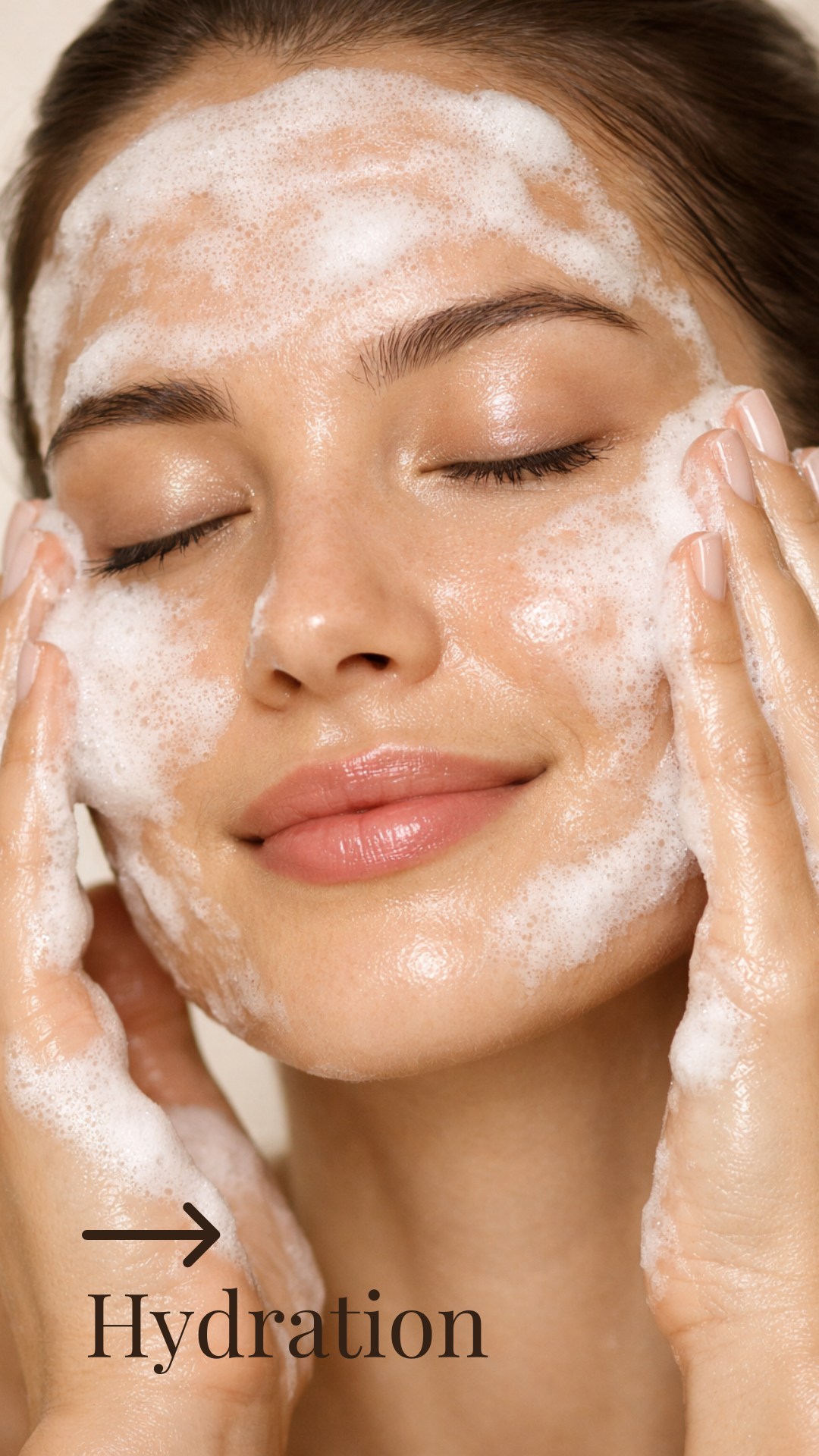 A woman with closed eyes applying a foamy facial cleanser to her face during skincare routine, with the word 'Hydration' and an arrow pointing to her cheek.