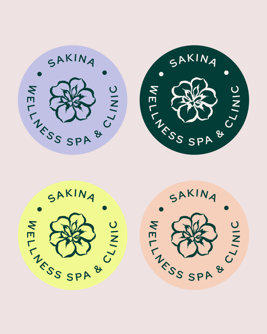 Four circular logos for SAKINA Wellness Spa & Clinic in different colors: lavender, dark green, yellow, and peach, featuring a flower at the center.