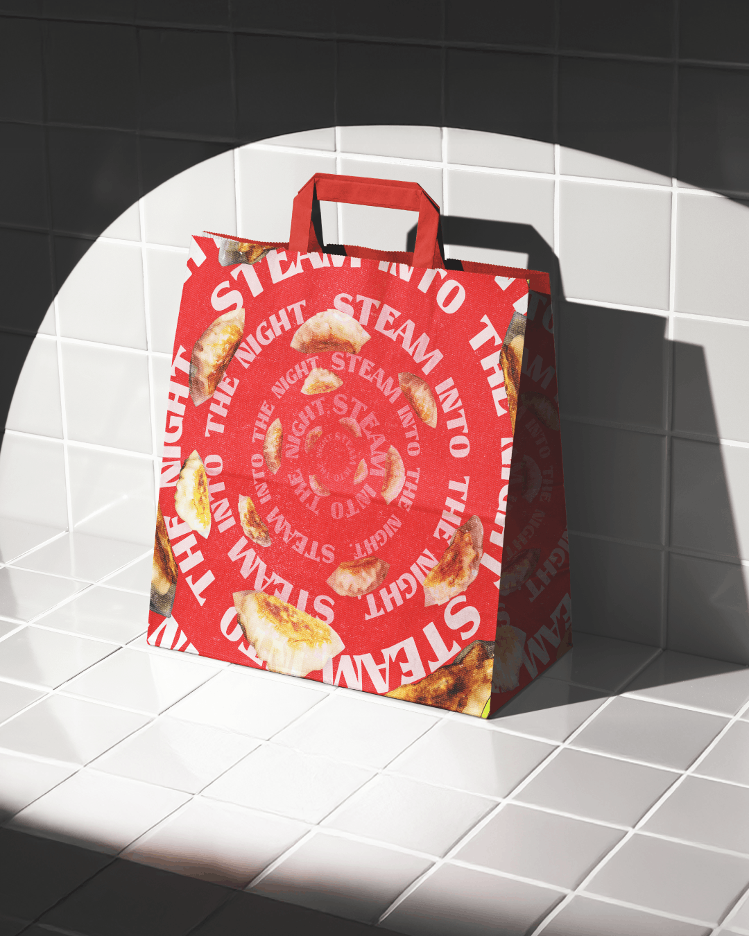 A red shopping bag with a circular pattern of the words 'STEAM THE NIGHT' and images of fried dumplings, placed on white tiled surface with a partial shadow.