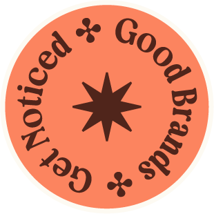 A circular logo with a peach background, black text reading 'Good Brads * Noticed *', and decorative black star and flower symbols.