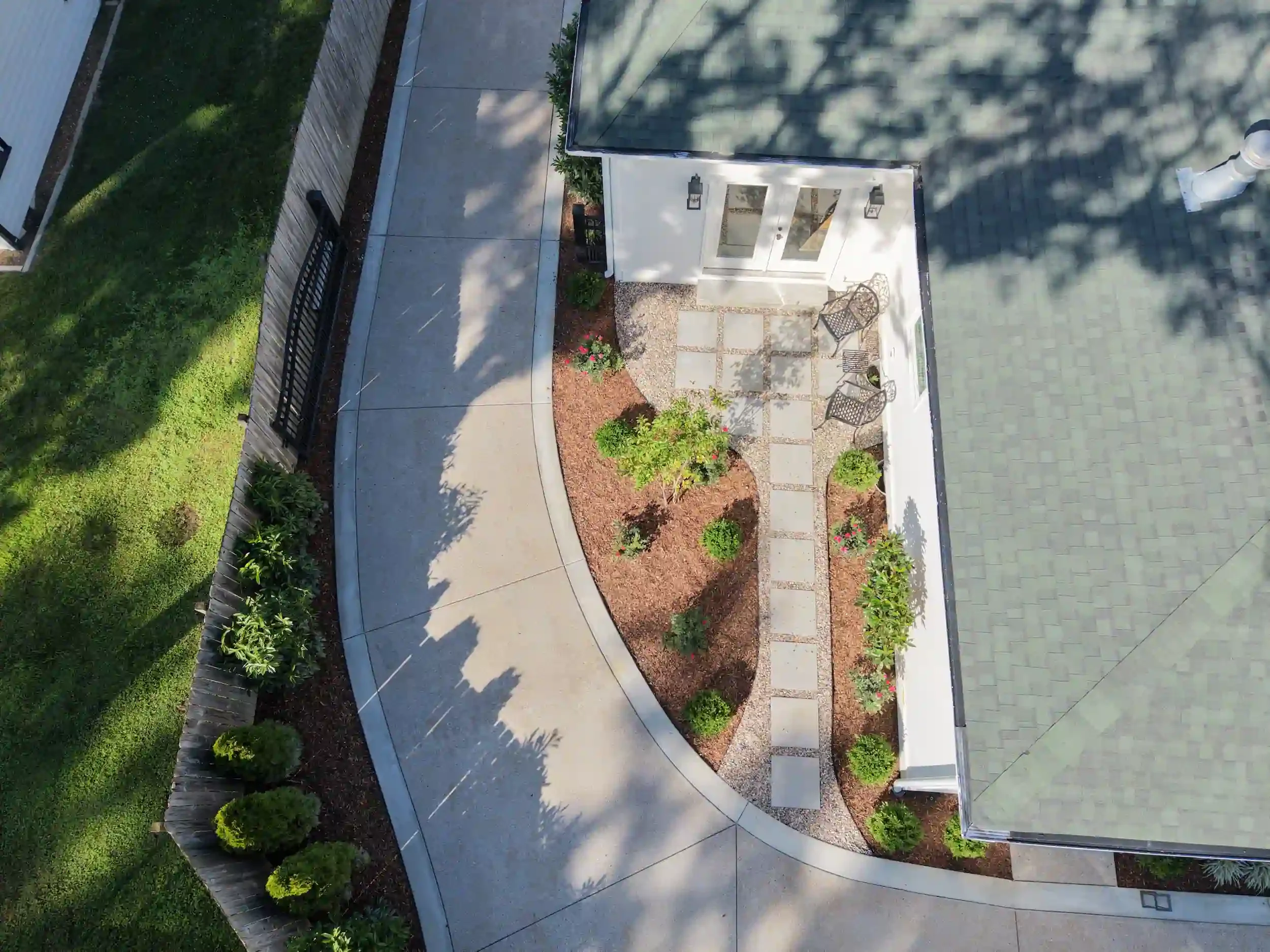 Aerial view of landscaped side yard with curved walkway and stepping stones