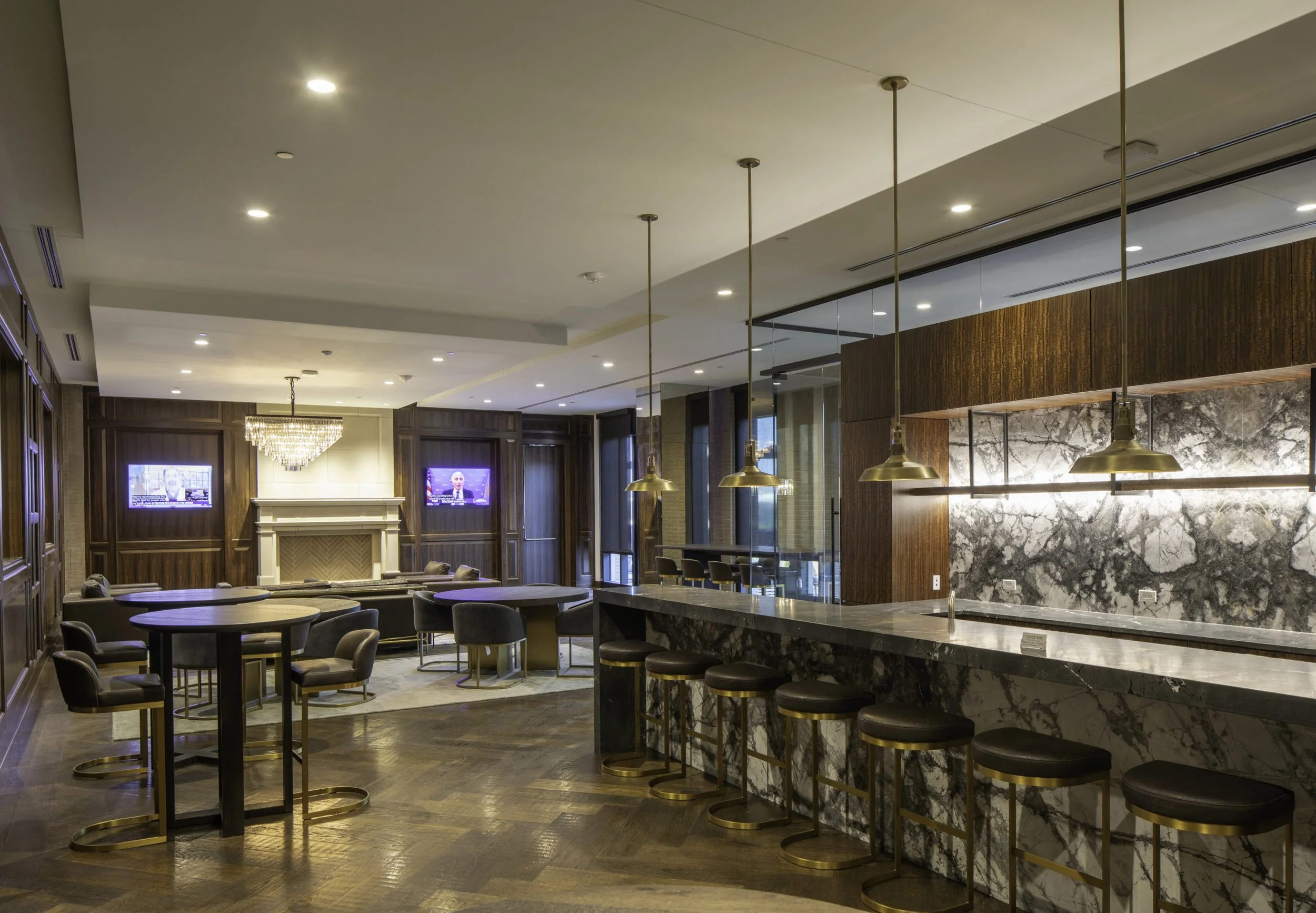 Elegant lobby with seating area, marble bar, and TV screens