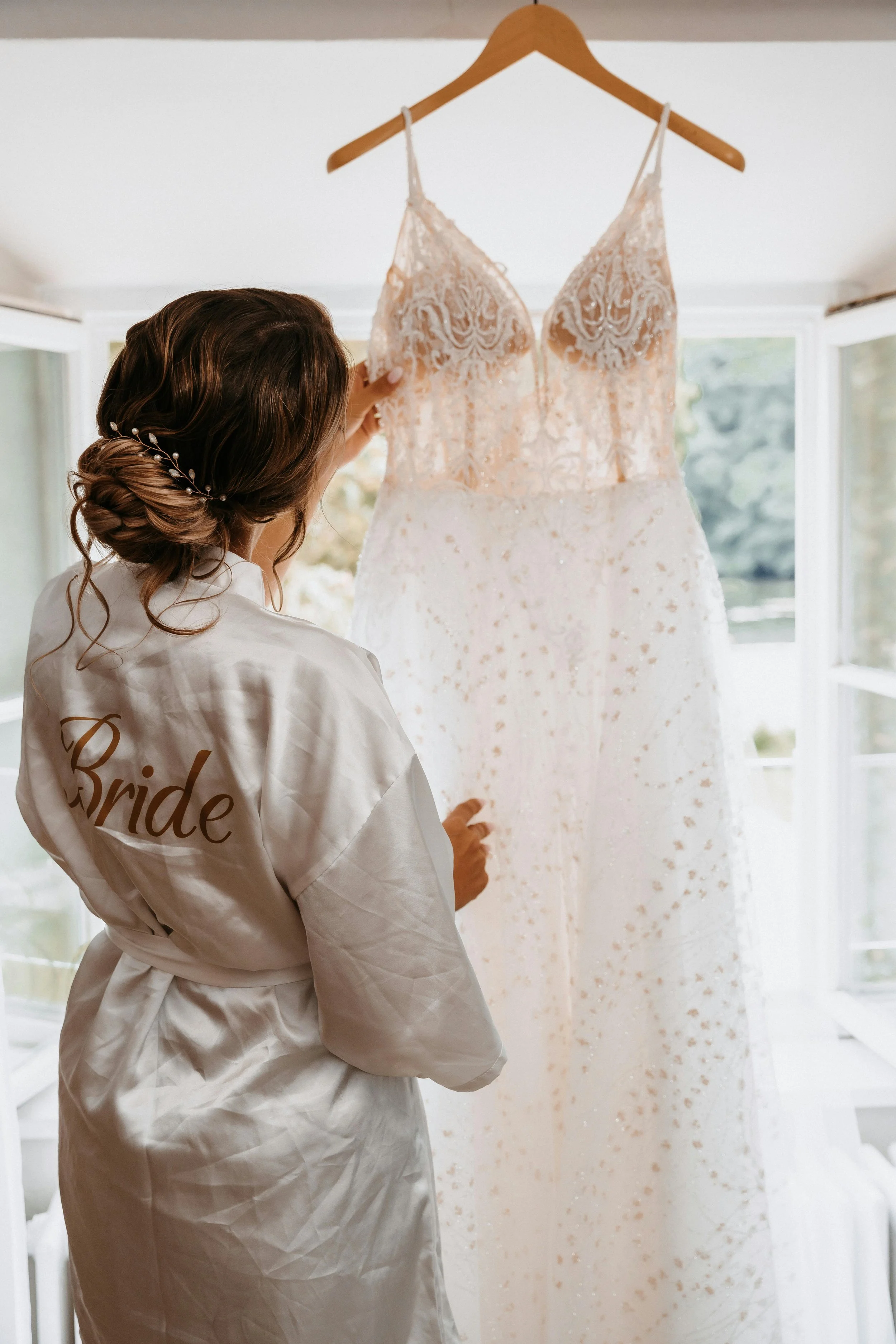 Bride looking at her wedding dress.