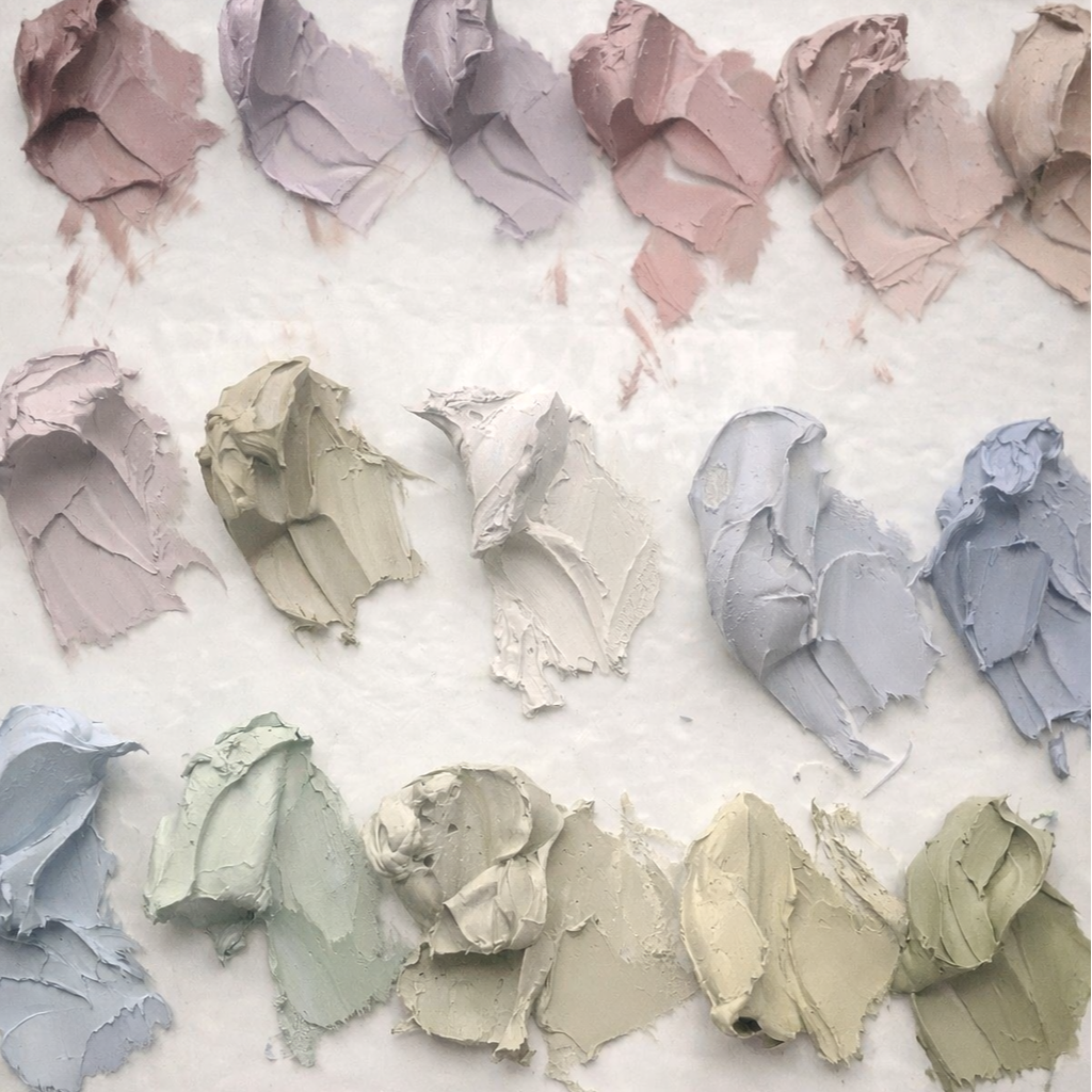 Paint swatches in pastel shades arranged in a pattern.